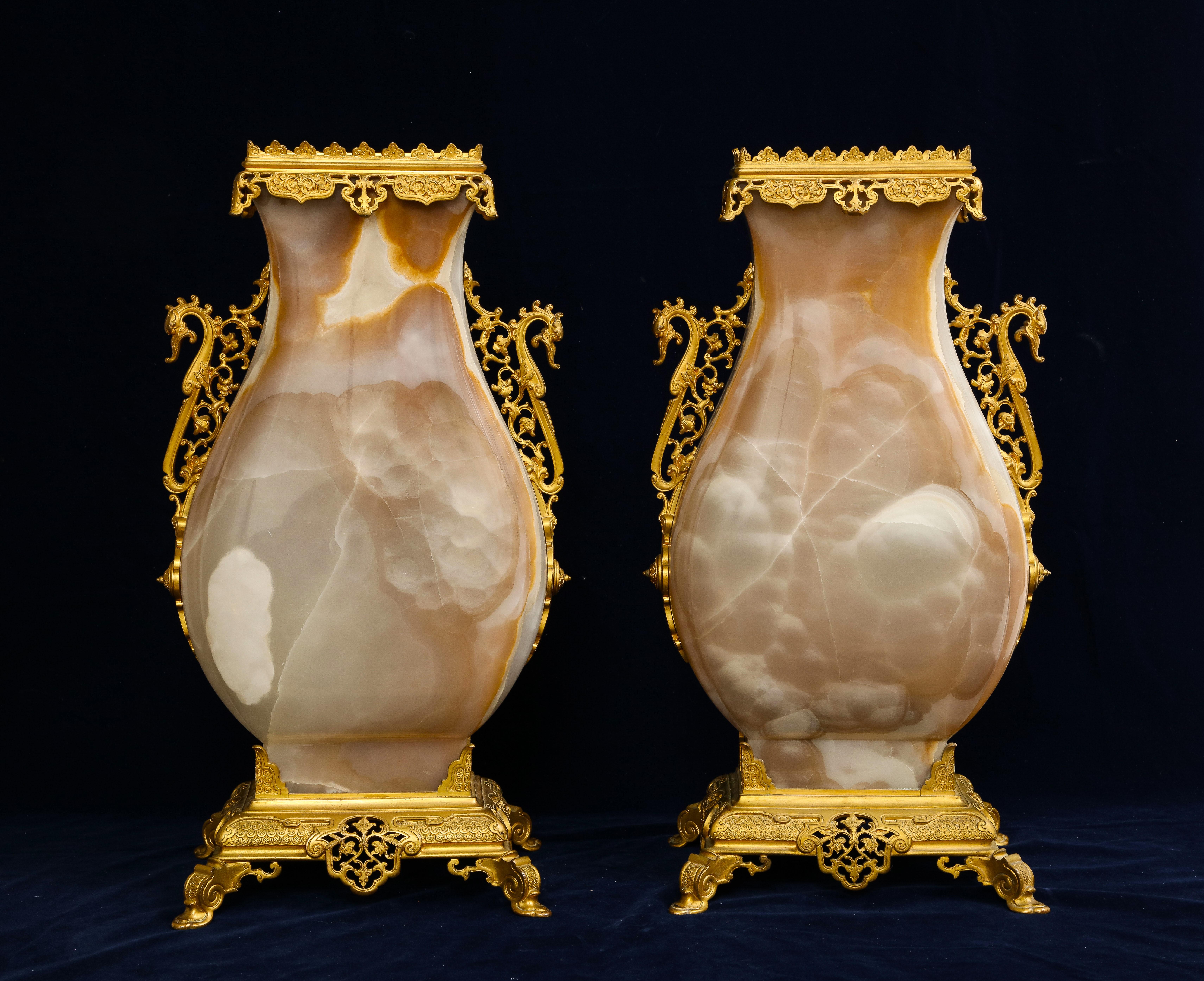 A very large pair of 19th Century French Louis XVI Style Ormolu Mounted Carved Agate Vases, Attributed to Édouard Lièvre. Each vase is massive with a large-scale hand-carved and hand-polished agate body which is mounted with wonderful ormolu mounts.