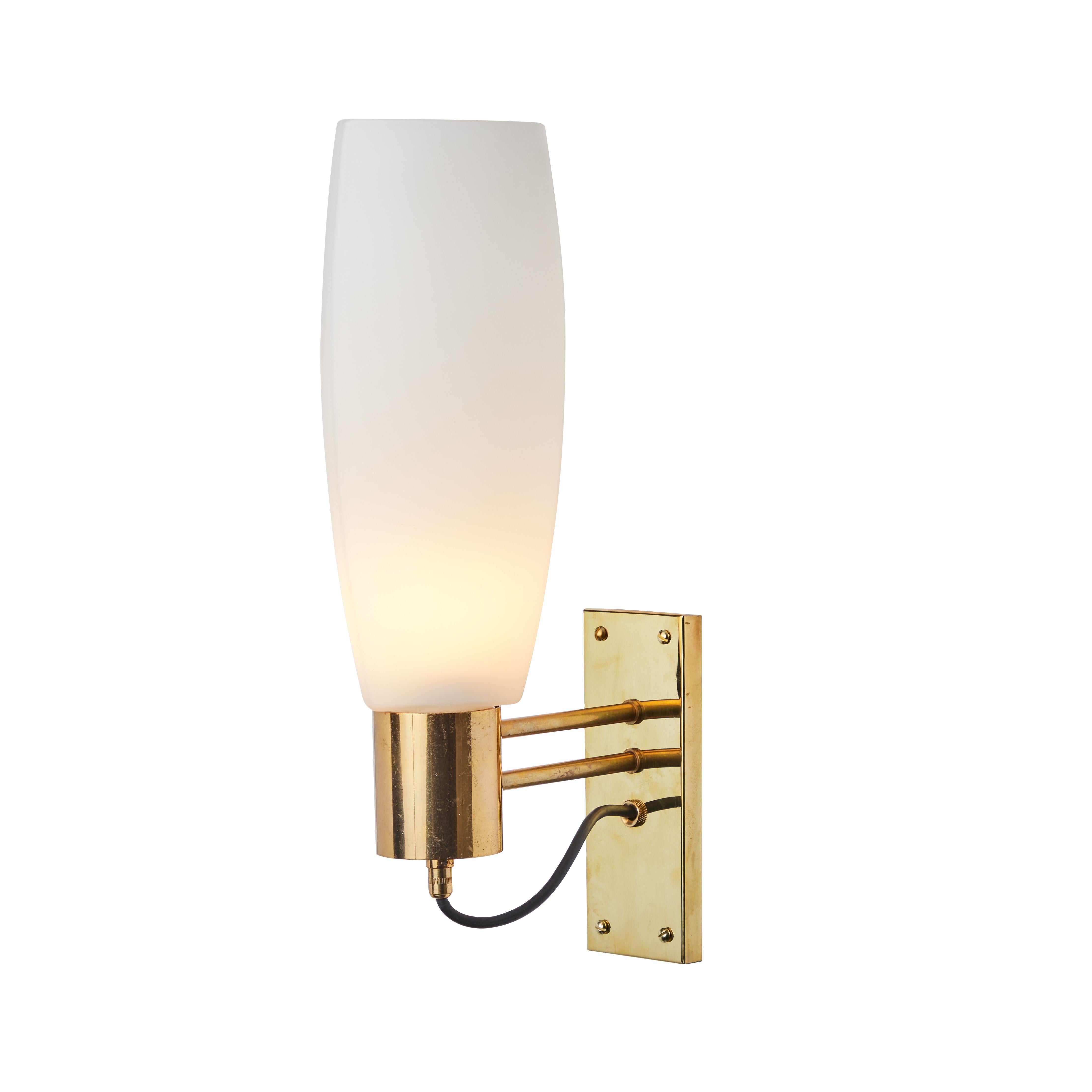 Large pair of 1950s Stilnovo opaline brass and glass sconces. Executed in brass with a sculptural three sided opaline glass. An incomparably clean and refined design characteristic of midcentury Italian lighting at its highest level.

Price is for