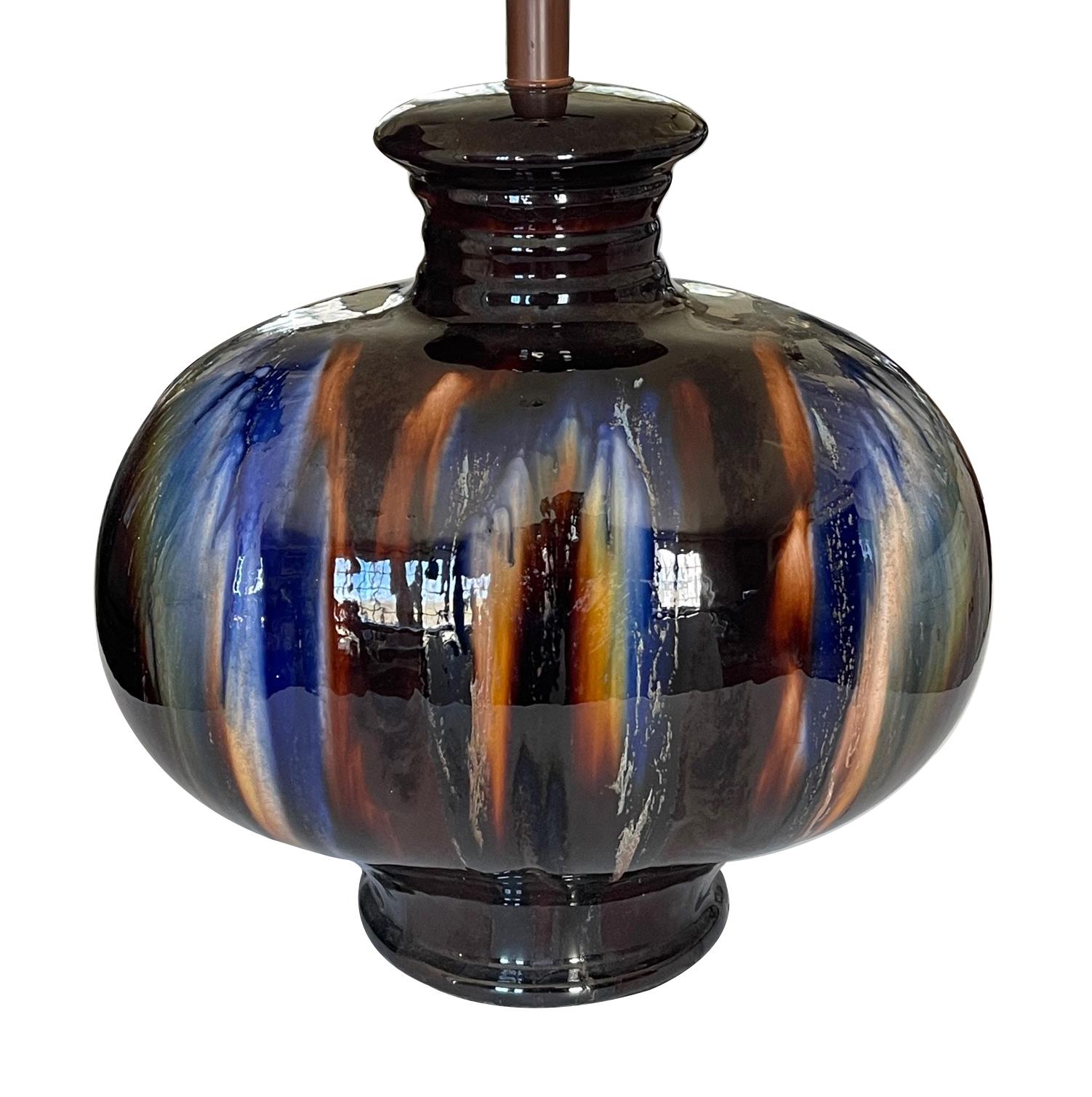each oblong ceramic lamp with rich blue and burnt sienna drip glaze