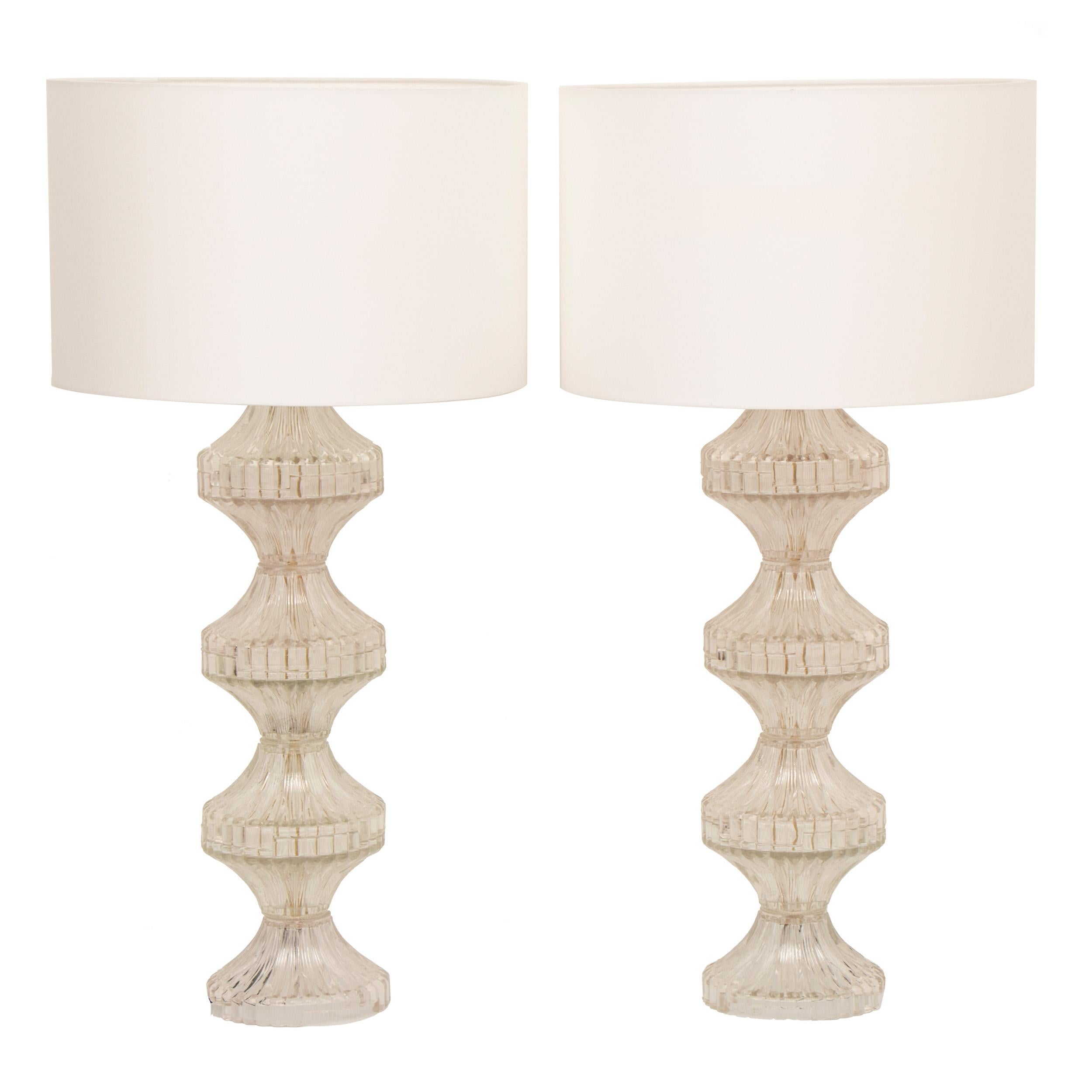 A stunning large pair of Italian 1960s pressed glass table lamps including new white silk shades. Rewired and PAT tested with a black twisted silk flex. The on/off switch is situated in the base of the chrome bulb socket. The chrome top plate on one