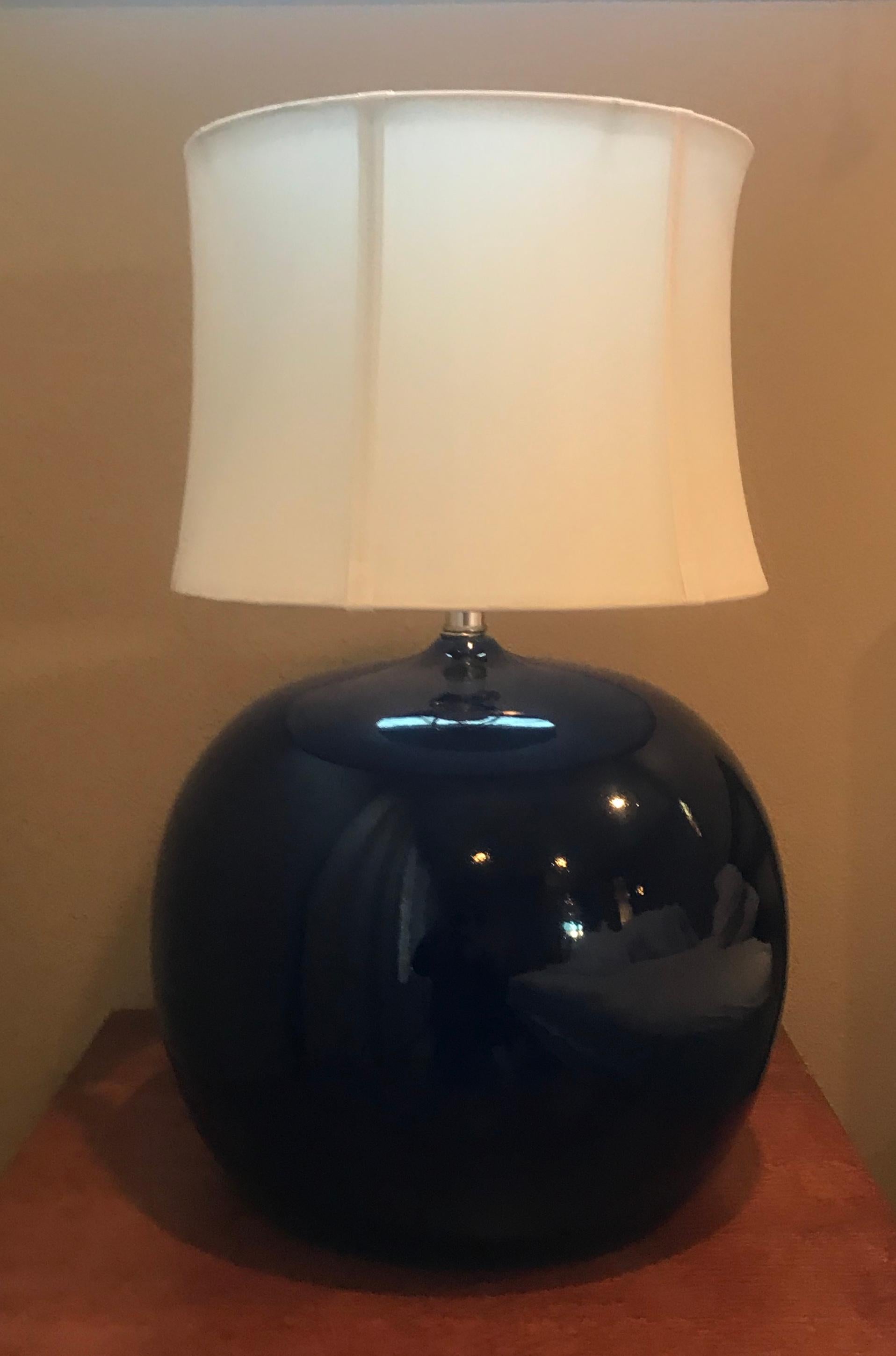 An orb shaped pair of ceramic 1970s Portuguese table lamps in a dark cobalt blue with chrome hardware. Rewired.