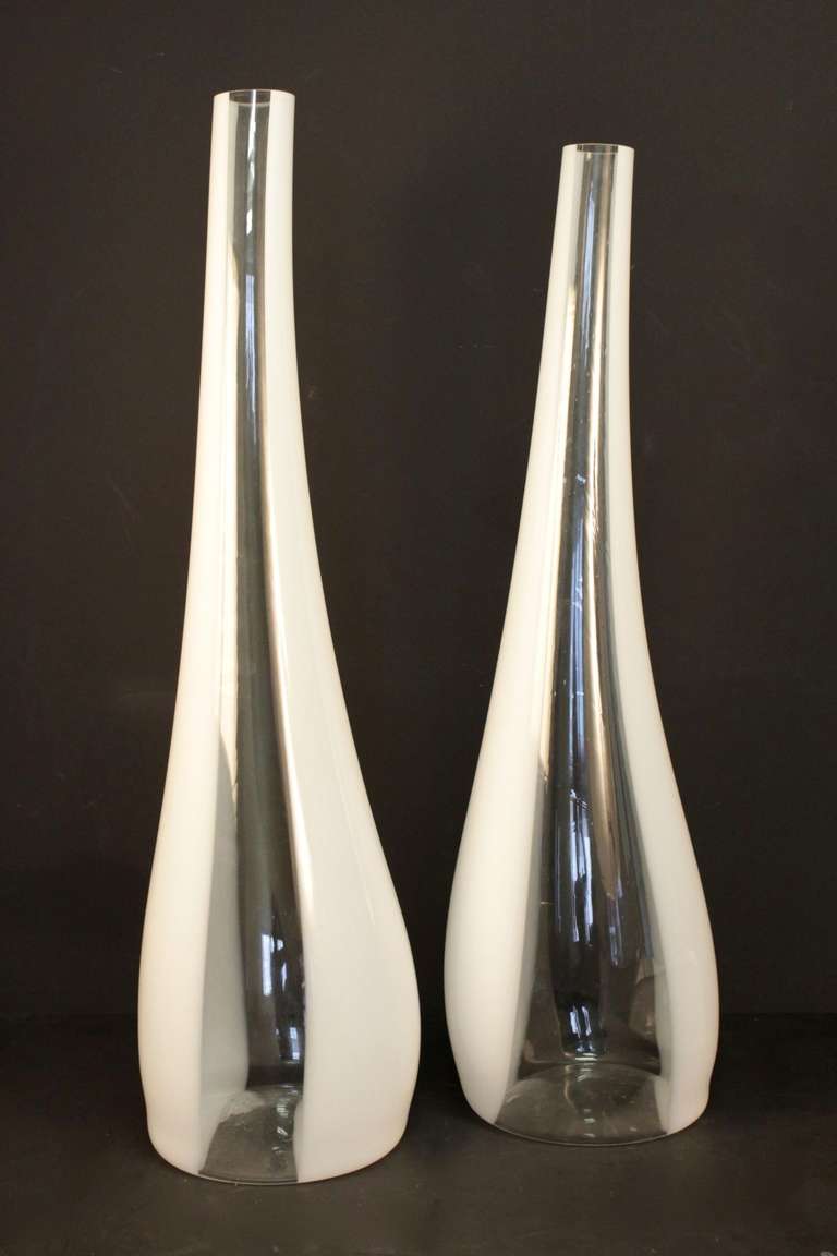 
Large pair of Murano glass stem vases from the 1970s. 
Composed of two large vases in thick Murano glass, handmade, two colors, transparent and white stretched in the direction of the height.
Either decorative vase, or vase that can receive