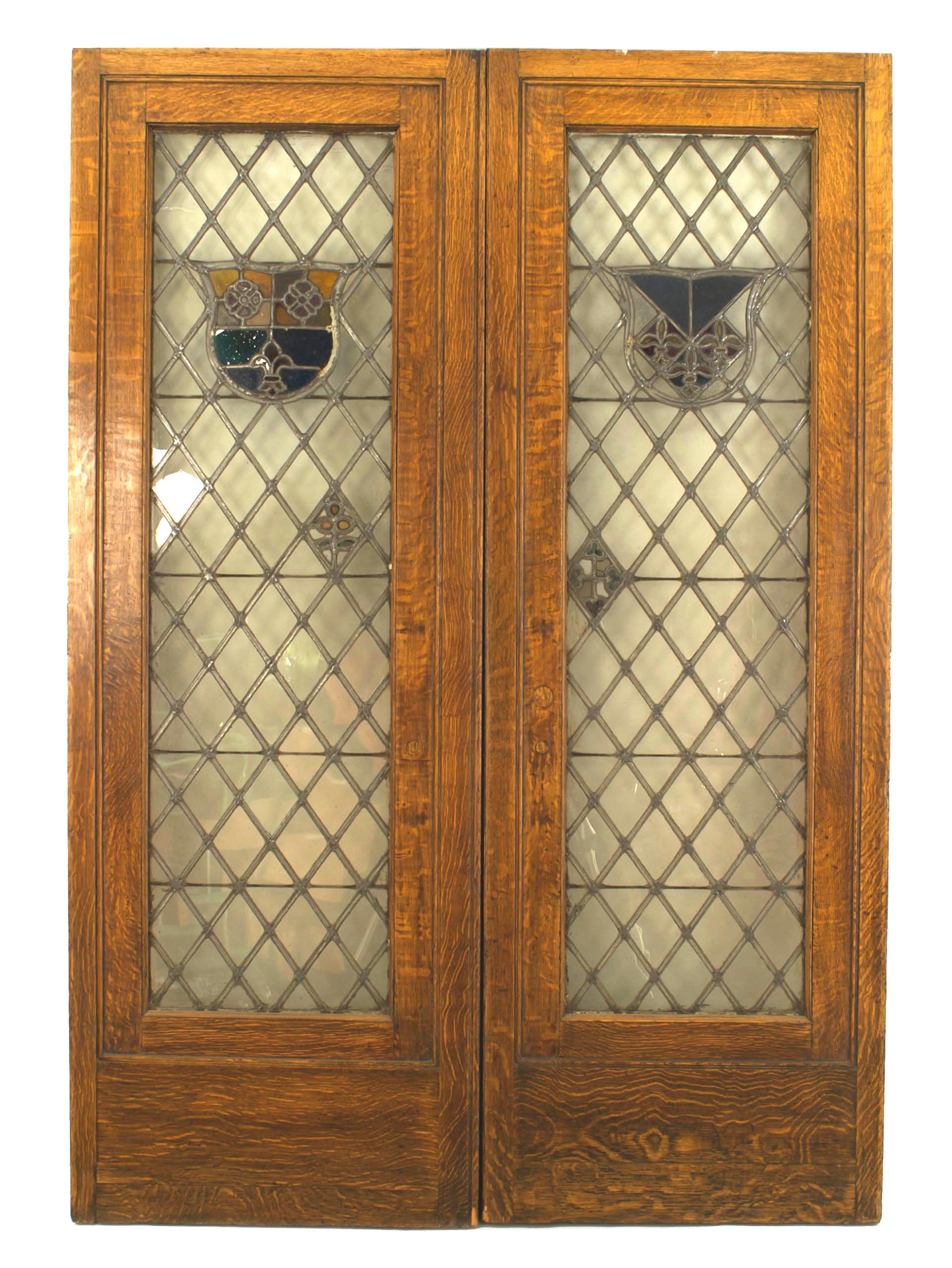 Pair of American Victorian large golden oak framed doors with leaded glass crest (as is- with minor hairline cracks & missing hardware) (PRICED AS Pair).
