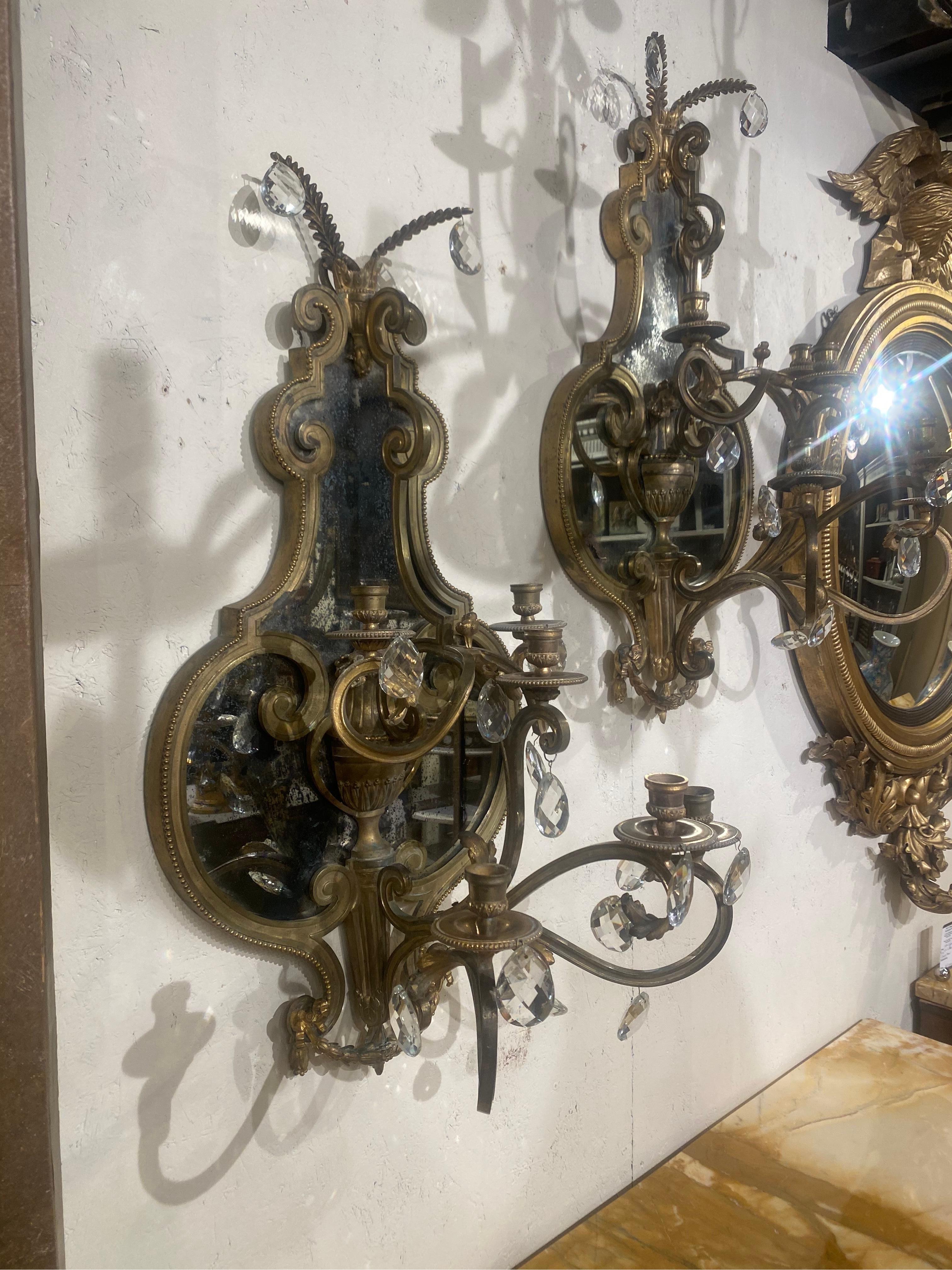 Large pair of 19th century French bronze and mirrored sconces. Measures: 30.35