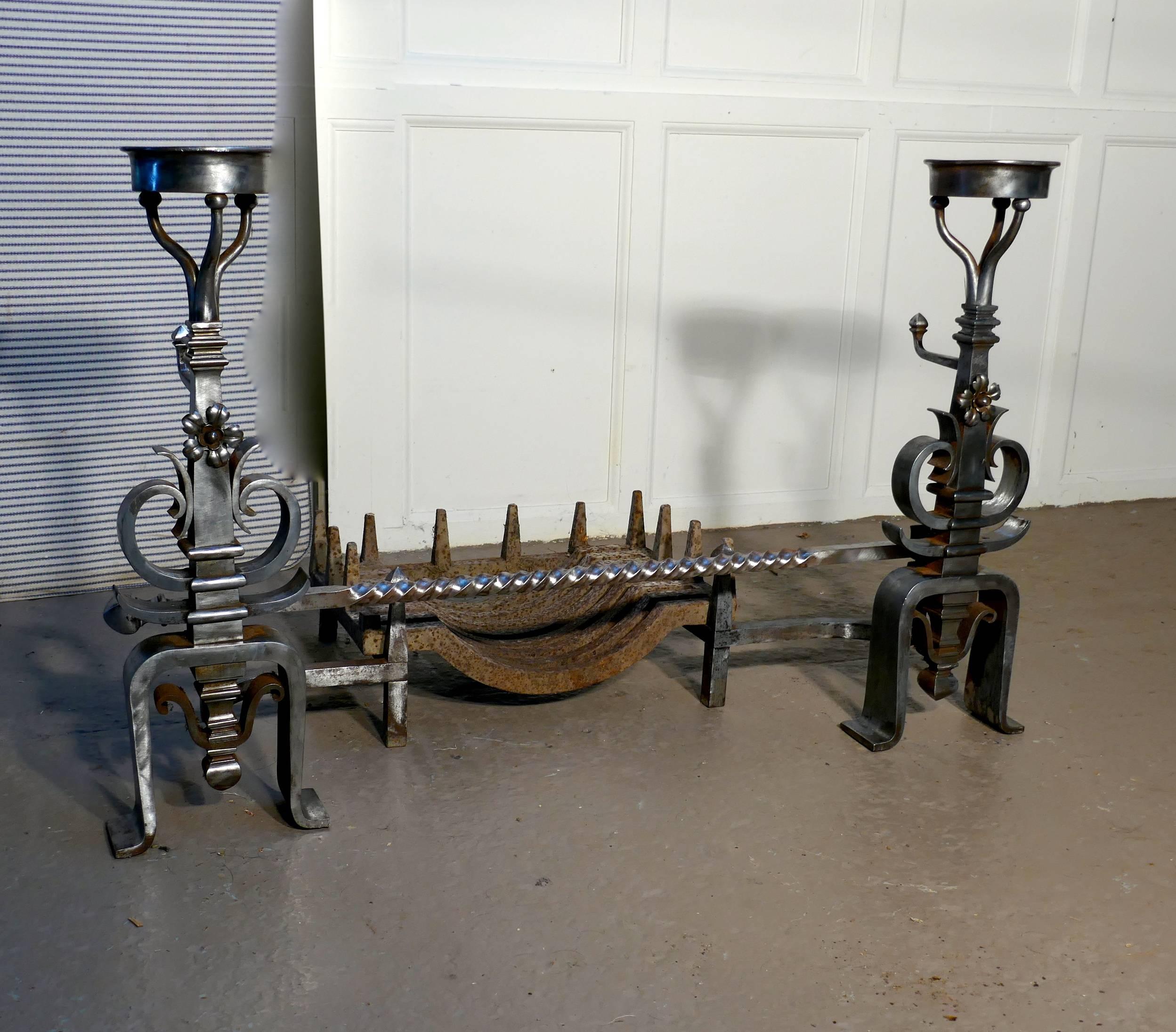 Large pair of 19th century French iron andirons or fire dogs

This is a very large pair of bowl andirons, they are Blacksmith made with bowls to the top and spit rod, needless to say these are very heavy pieces.
The andirons are decorative and