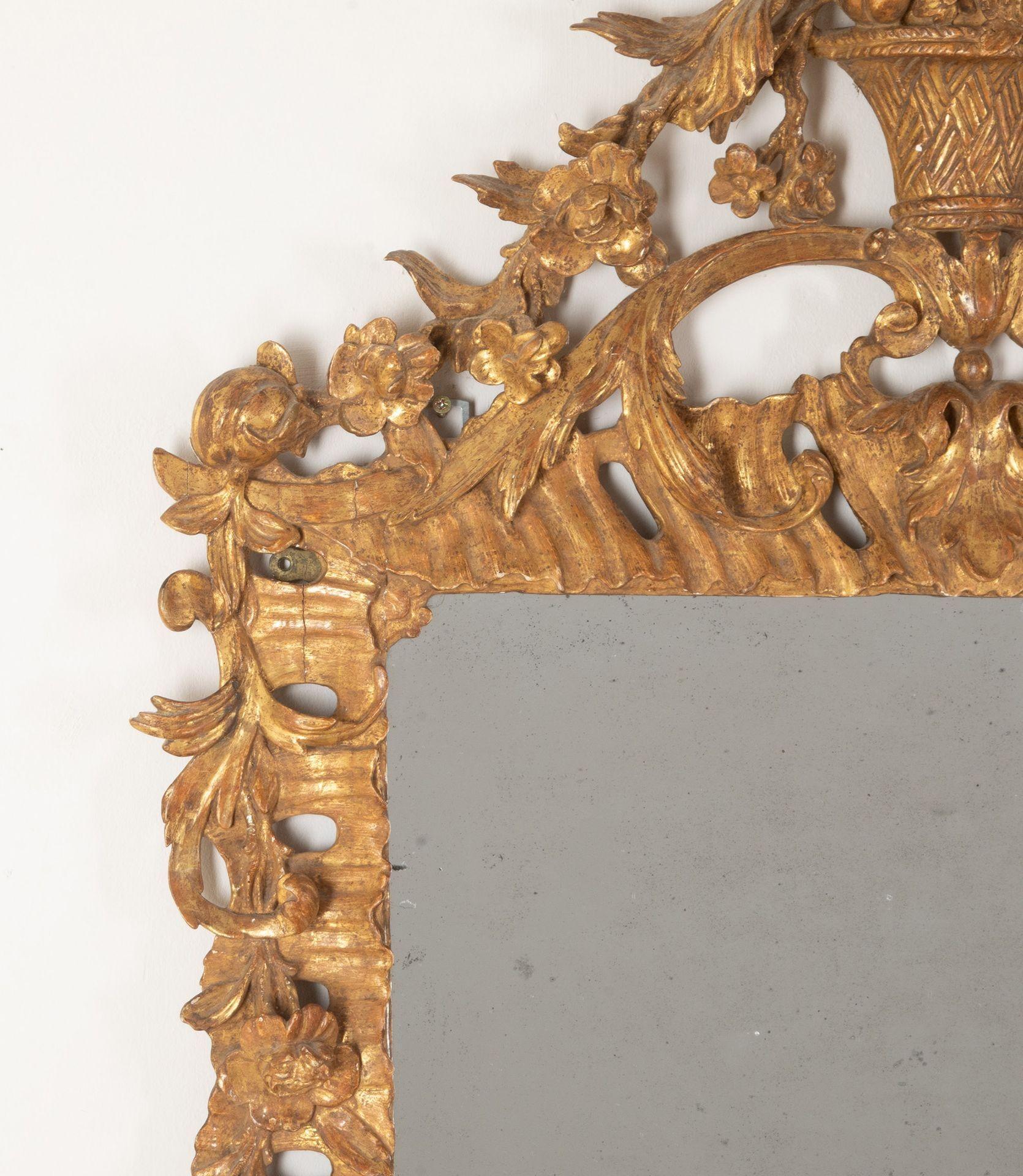 Un'ottima coppia di specchi inglesi intagliati e dorati della fine del XIX secolo, in stile rococò di Giorgio III. I piatti di mercurio rettangolari all'interno di una cornice traforata intagliata con rocaille, volute foliate, teste di fiori e