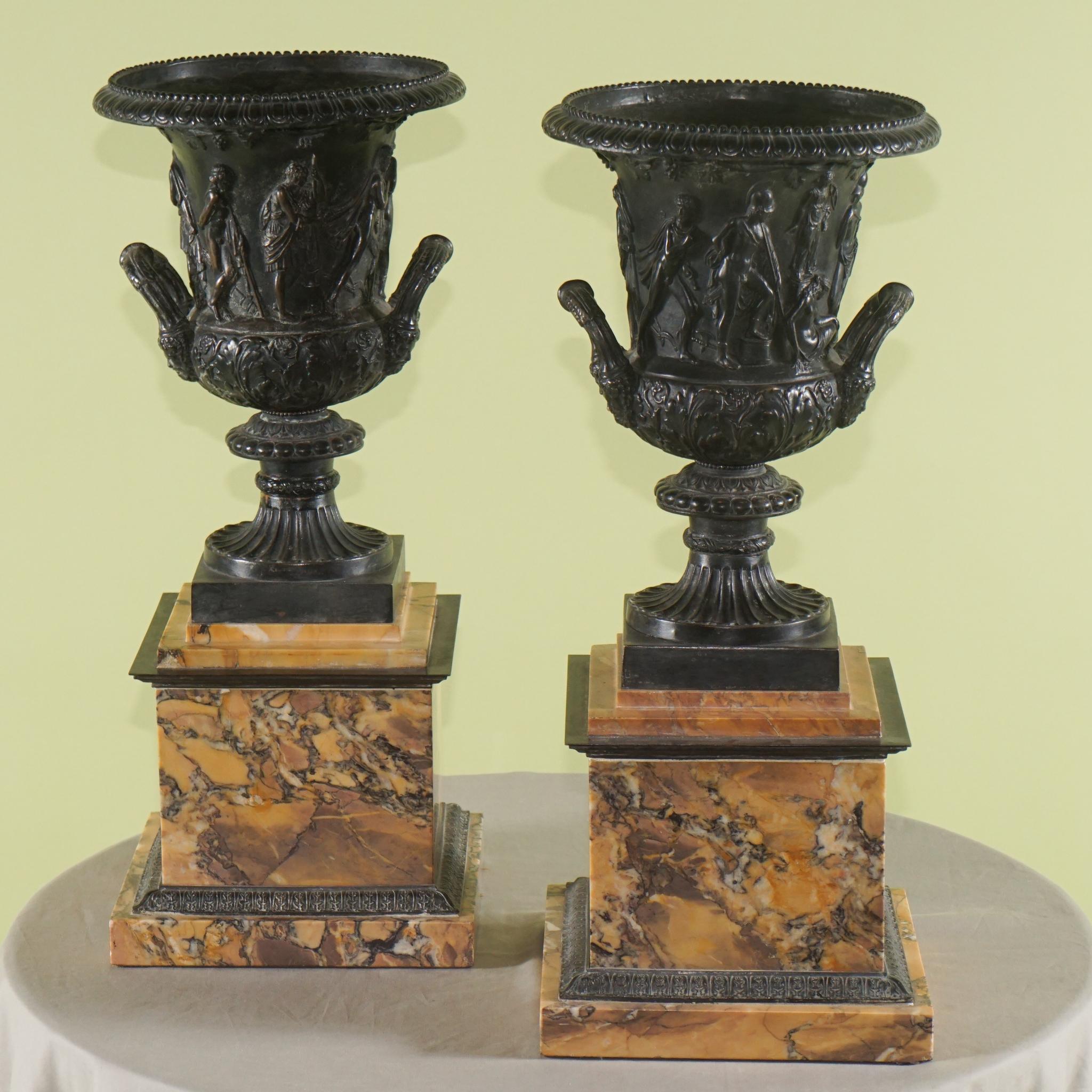 This impressive and large pair of decorative urns from the grand tour are designed to recreate the famous Medici Vase. The grand vase a 1st century AD Greek massive carved marble urn meant to grace a great roman villa as a garden ornament now