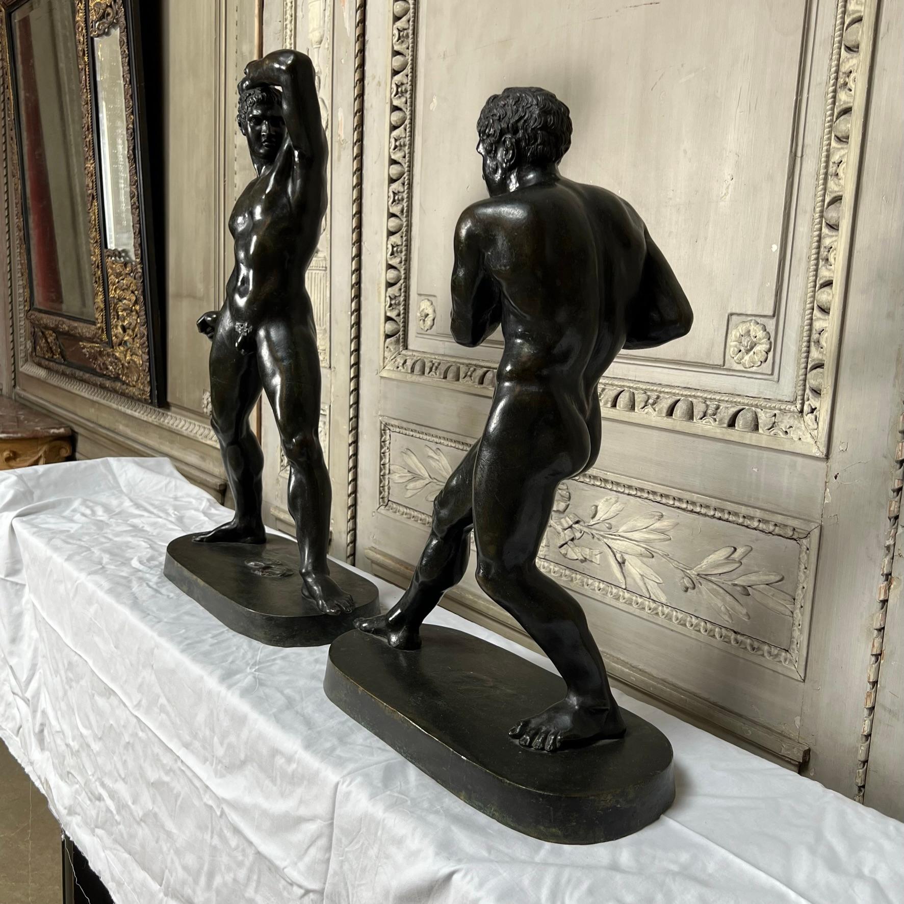 A large and fine pair of 19th century Italian male nudes depicting the Greek boxers Creugas and Damoxenos.  These bronzes have a wonderful old patination of dark gun metal with some verdigris. 