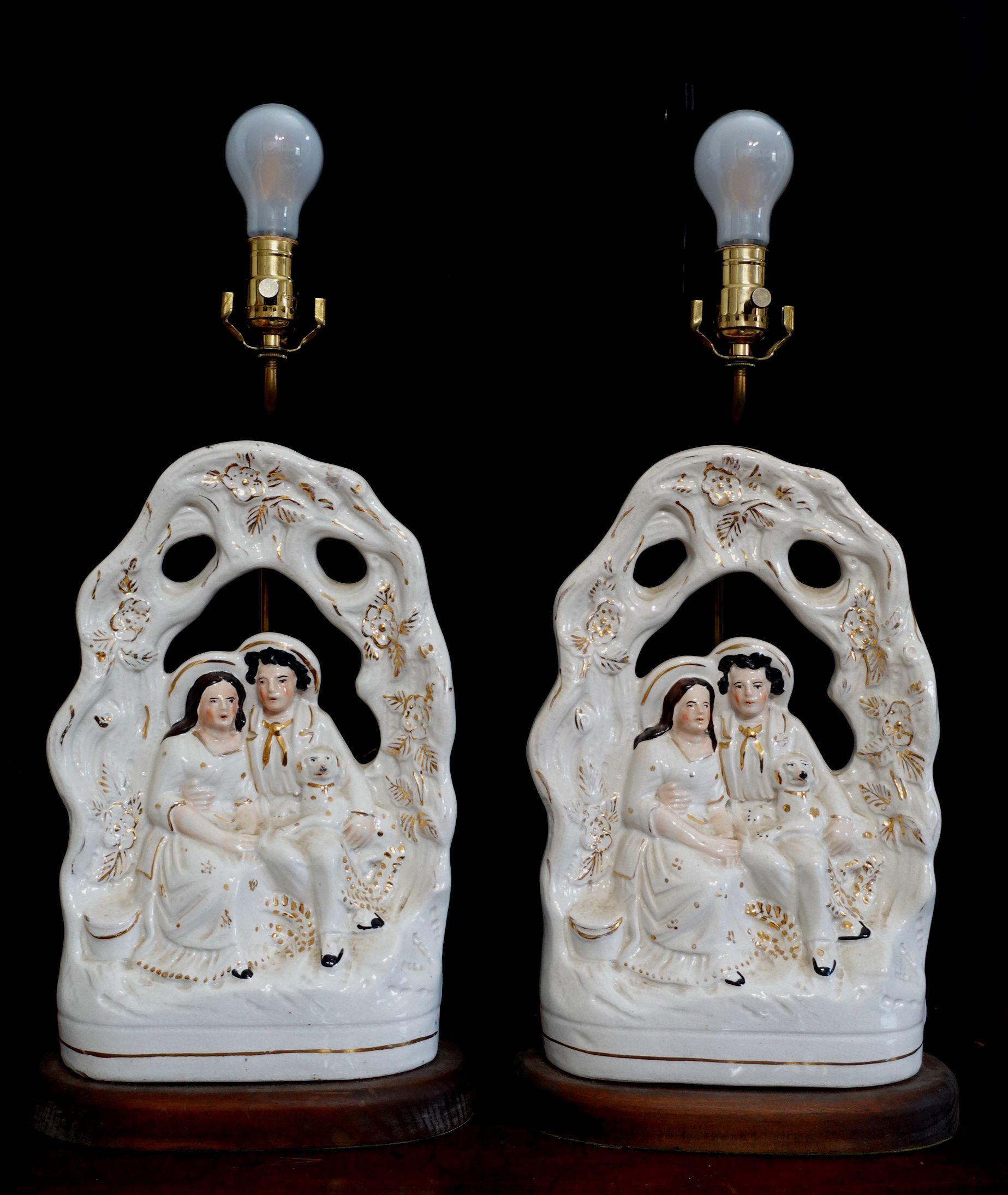 Beautifully painted and impressive scale Staffordshire group of Staffordshire Arbor Couple Pottery Figurine the overall white glaze applied to the entire porcelain, is a wonderful effect, with gilt highlights throughout. 
They were mounted on