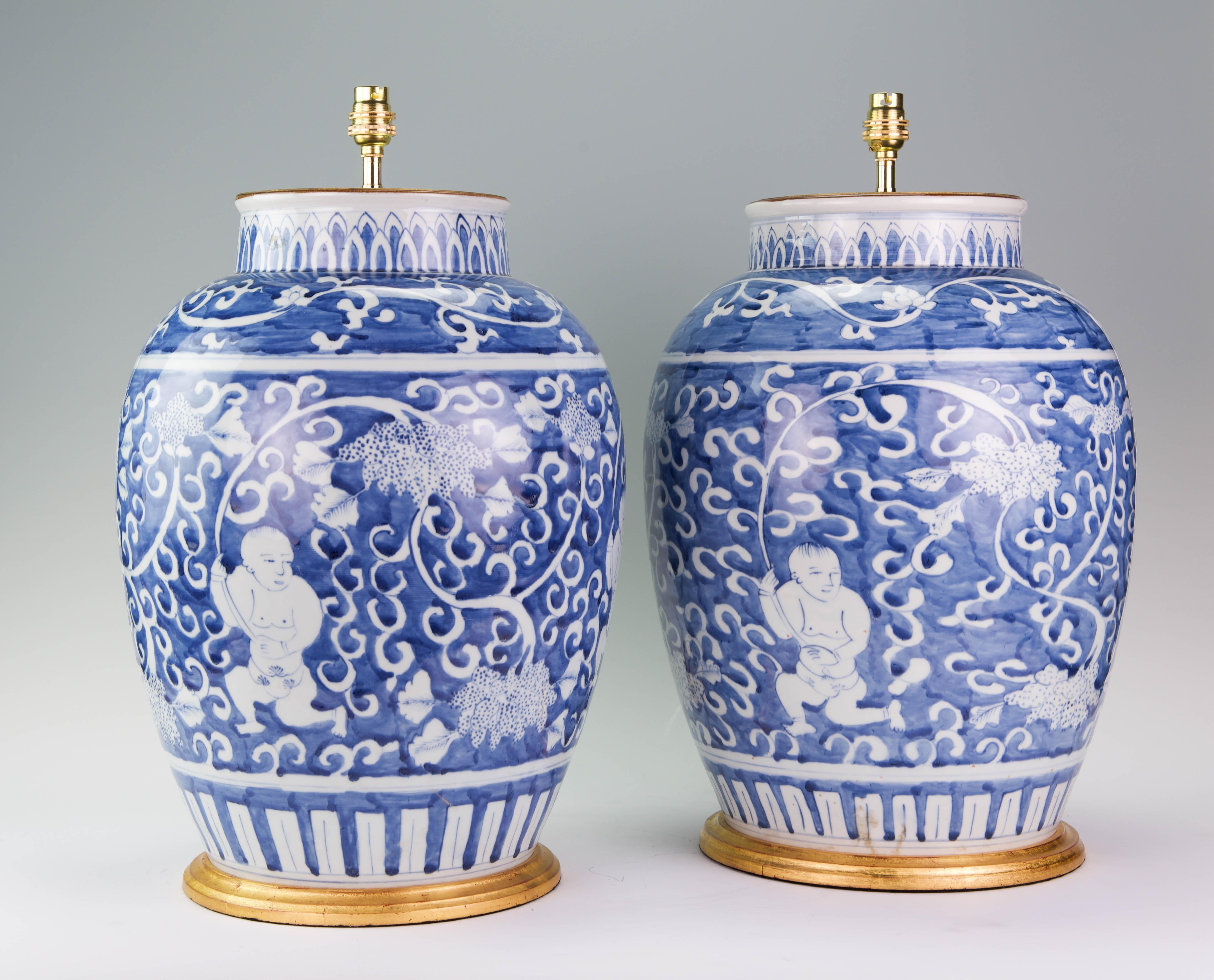 A fine pair of large Chinese blue and white Kangxi style baluster vases, beautifully painted with Chinese figures in a stylised garden landscape, now mounted as table lamps with hand gilded tuned bases.

Height of vases: 18 in (46 cm) including