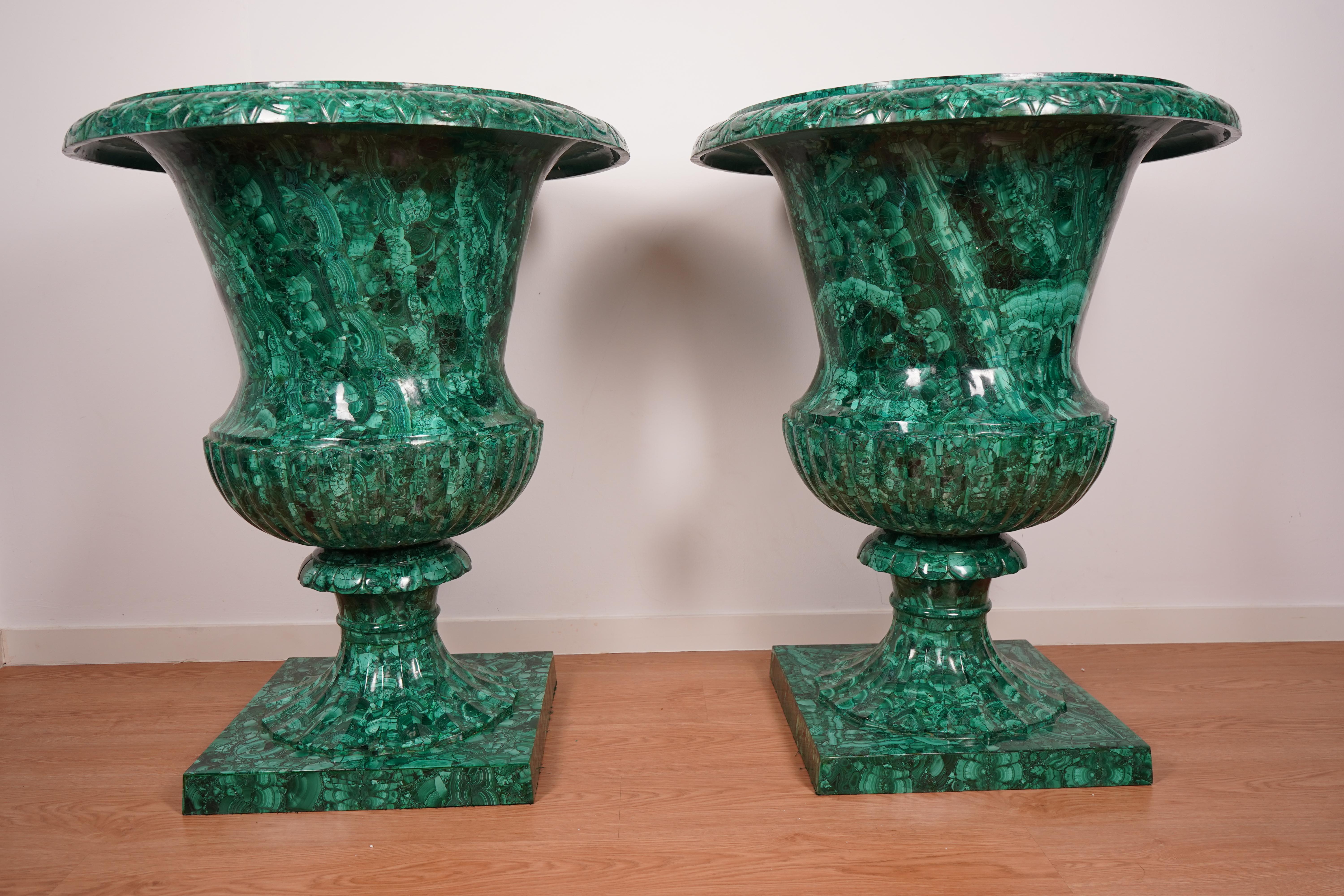 Impressive pair of monumental malachite vases from the 20th century, crafted from high-quality malachite with exceptional natural veining and deep green hues. These grand decorative pieces stand at an impressive height of 100 cm with a diameter of