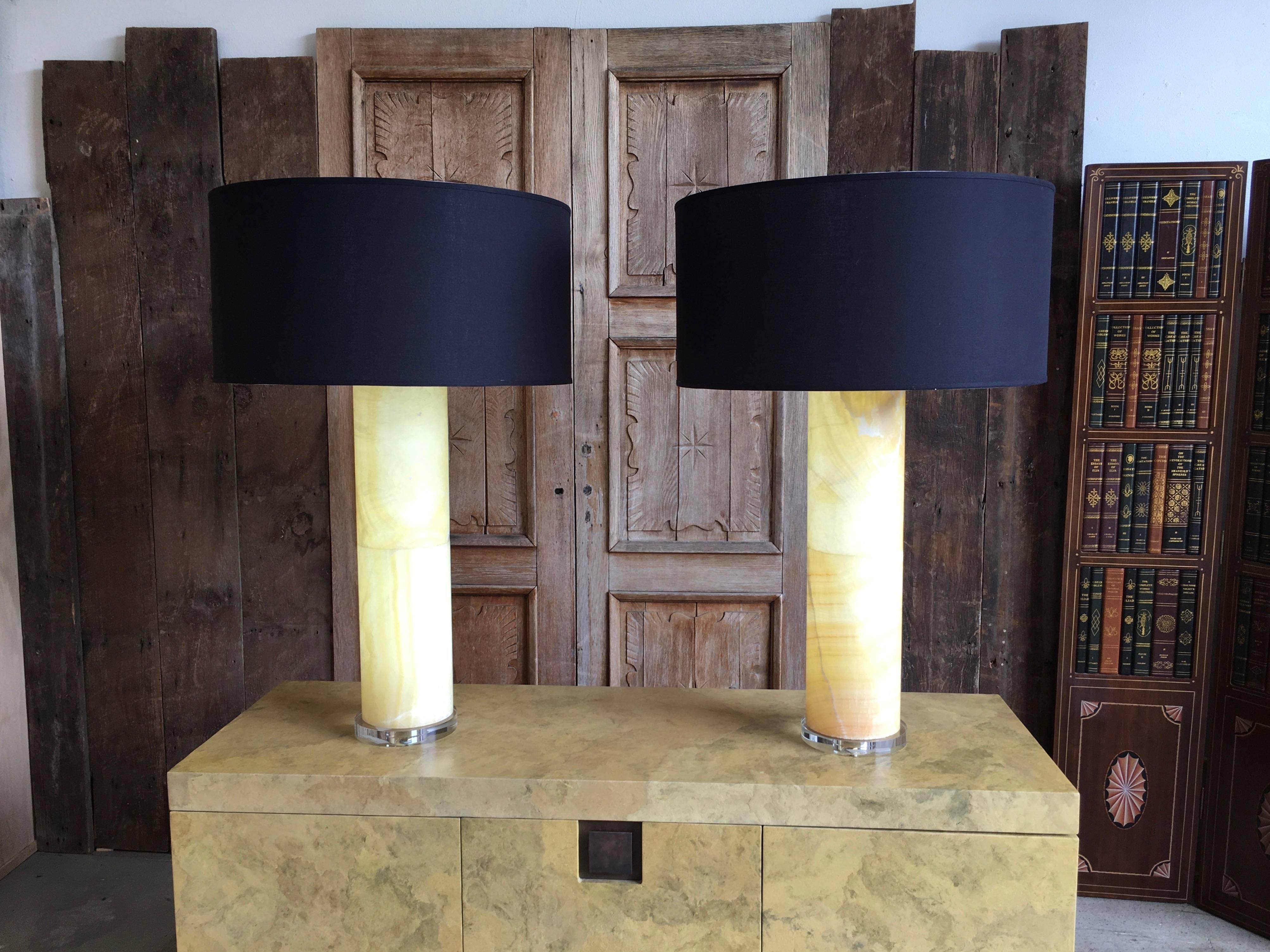 Modernist pair of oversized alabaster lamps on Lucite base
The lamps have lights inside the column with a separate switch for a night light glow affect
the alabaster base is 7.5