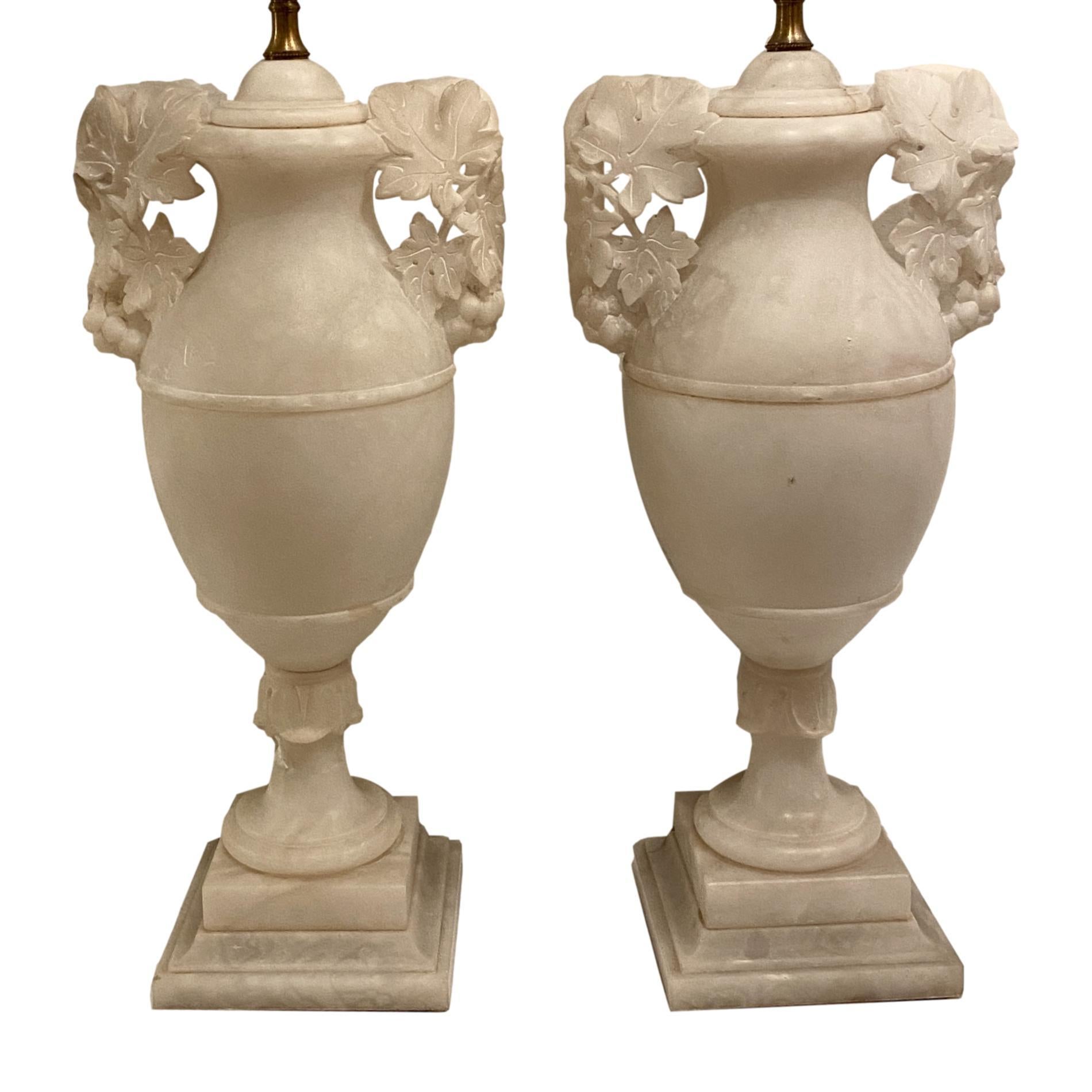 Pair of circa 1920's French carved alabaster table lamps with foliage motif open-work carved handles.

Measurements:
Height of body: 18