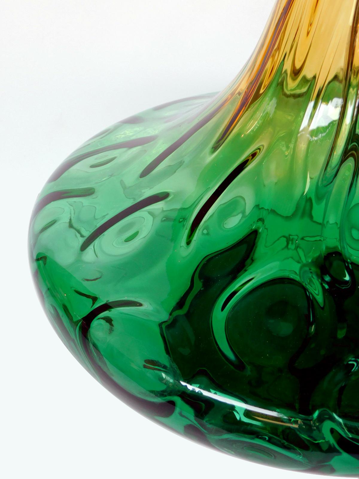 Each of decanter form with long flaring neck above a compressed spheroid body; all in a graduated yellow-to-green clear glass infused with large bubbles; 16.5
