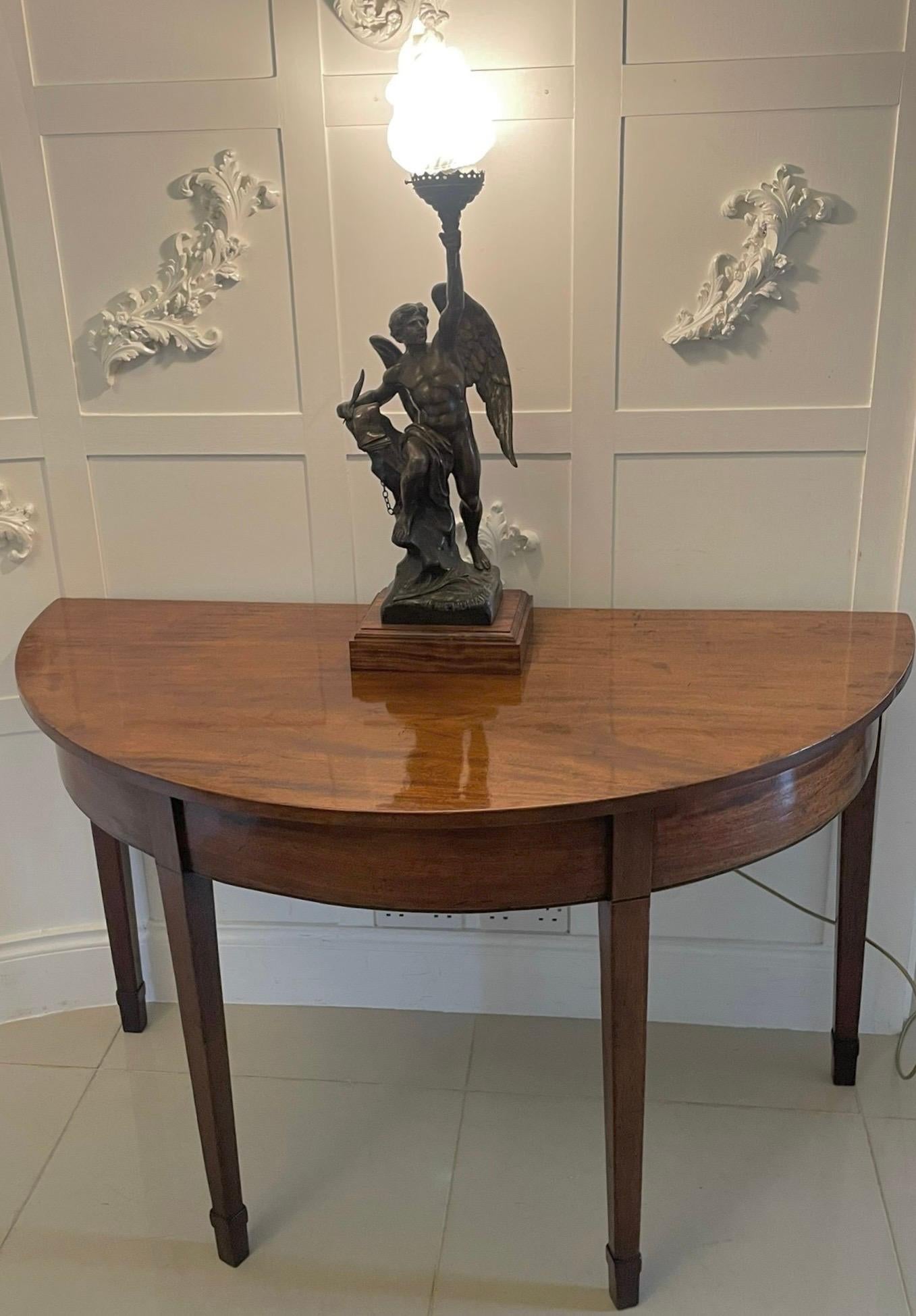 Large pair of antique George III quality  mahogany demi lune console tables having quality figured mahogany demi lune shaped tops above a figured mahogany frieze with ebony and satinwood inlay stringing.  They stand on four elegant mahogany square