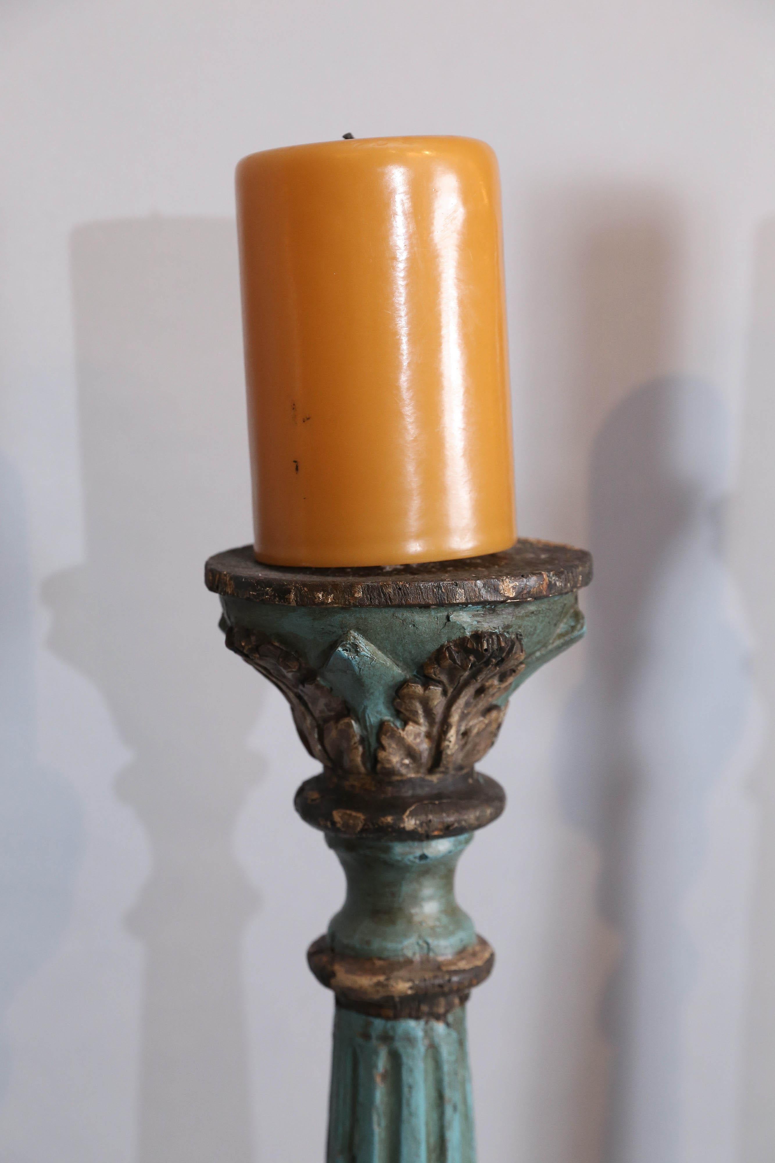 Large pair of antique Italian painted and gilt Altarsticks.

Altarsticks have a tripod base with swag carvings,
fluted Corinthium column, acanthus leaf decorartions
and painted blue with gilt.
 
 
 