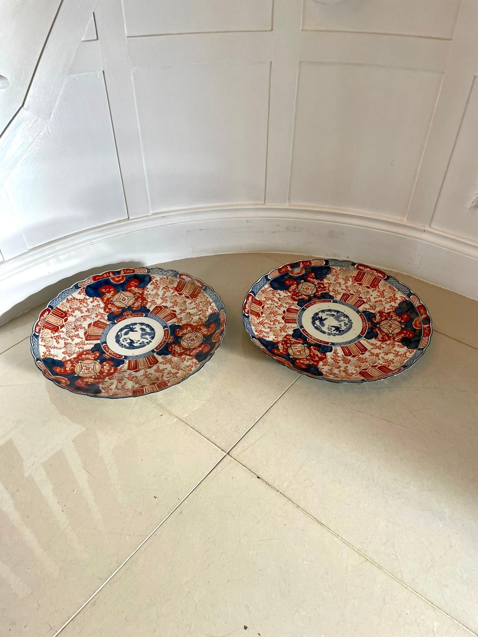 Large pair of antique Japanese quality Imari chargers having a scalloped edge and boasting fantastic hand painted panels in wonderful gold, red, blue and white colours 

In wonderful original condition 

H 5.5 x W 46.5 x D 46.5cm
Date 1900.
 
