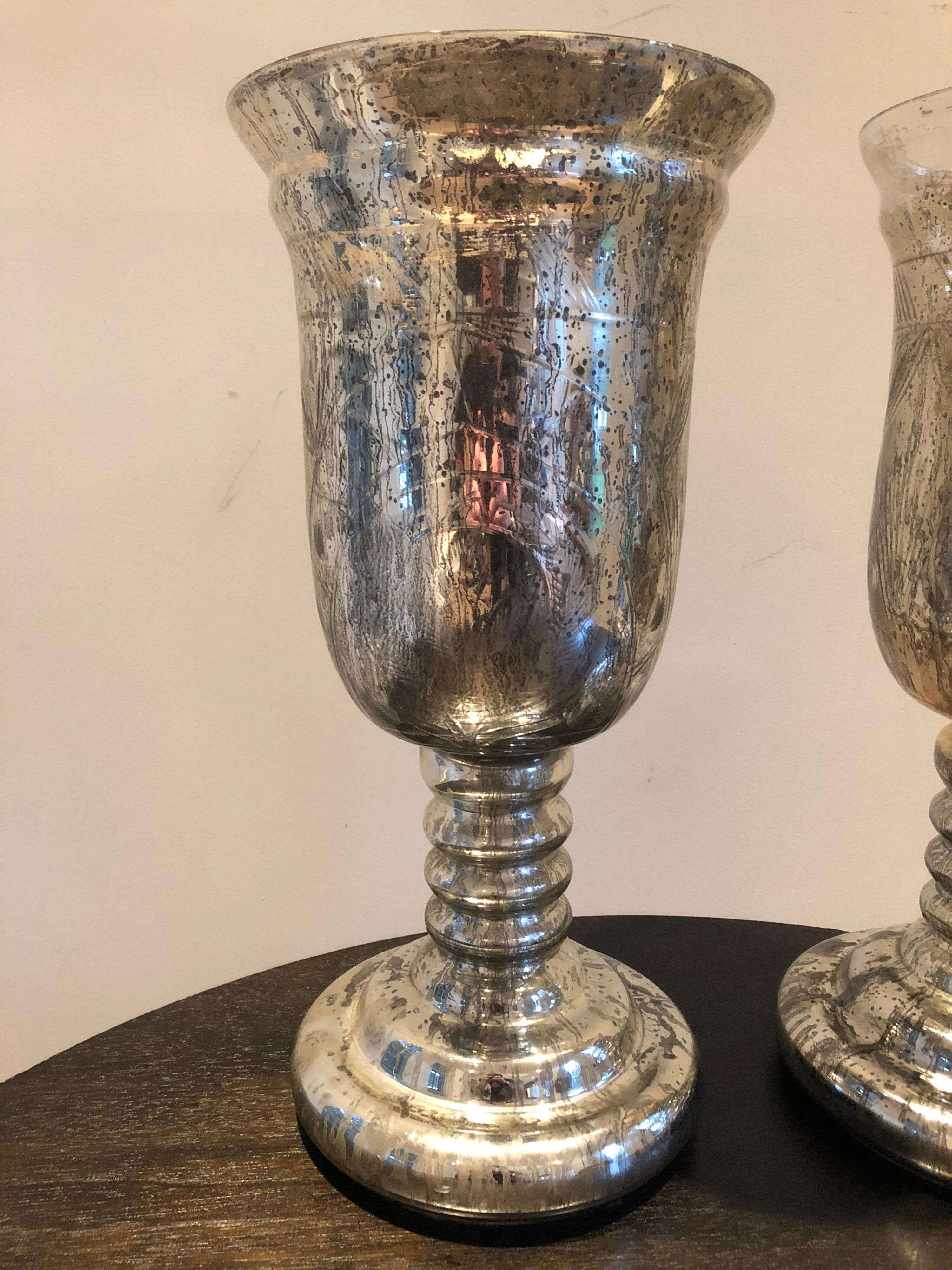 Large pair of antique mercury glass hurricanes or vases. Rare size, hand etched design and great patina. One is slightly larger because of the handmade quality of the piece.