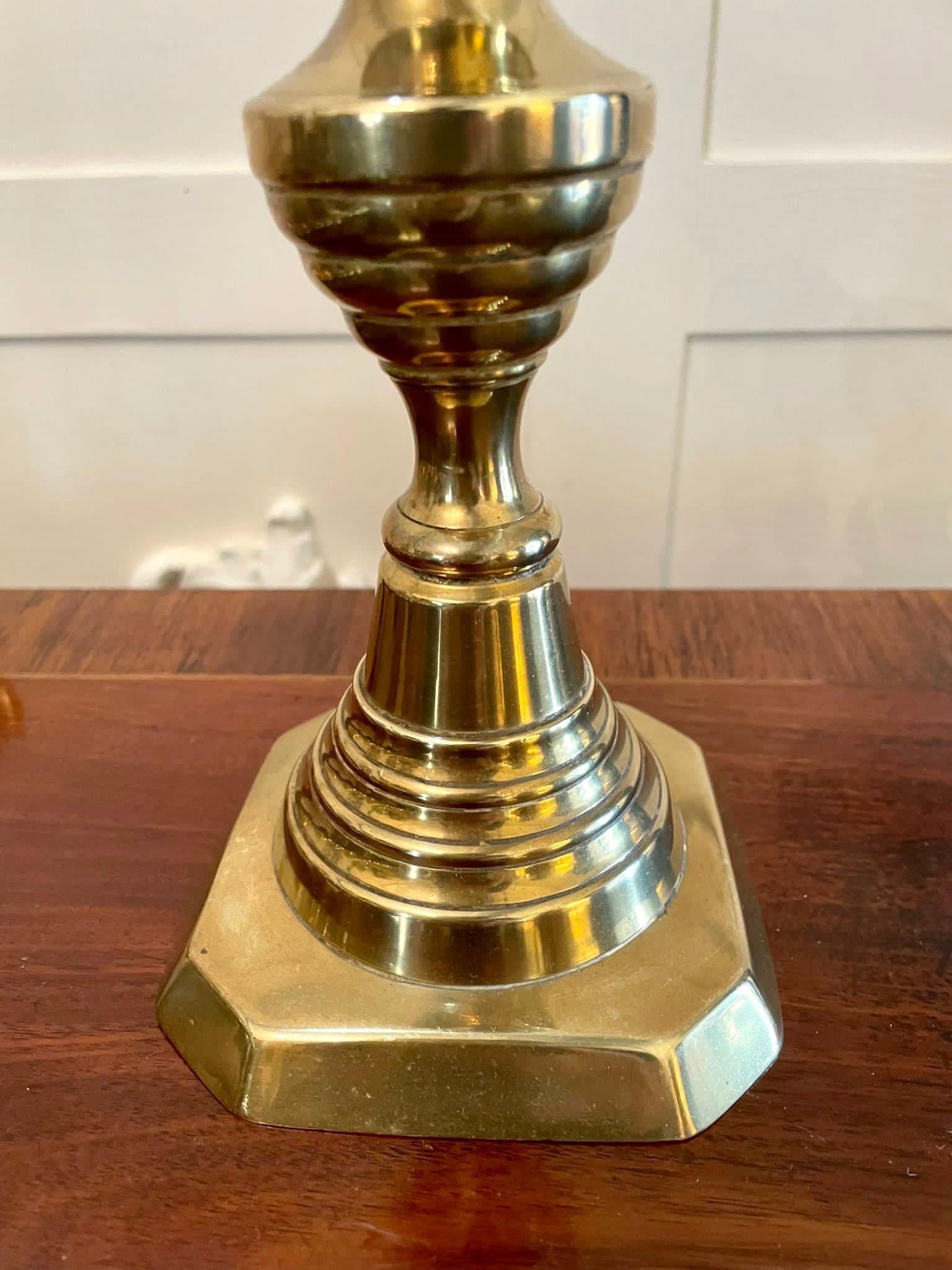 Large pair of antique Victorian brass candlesticks having a beehive and diamond shaped column raised on a square stepped base.

Measures: H 30cm 
W 11cm 
D 10.5cm 
Date 1860.
 