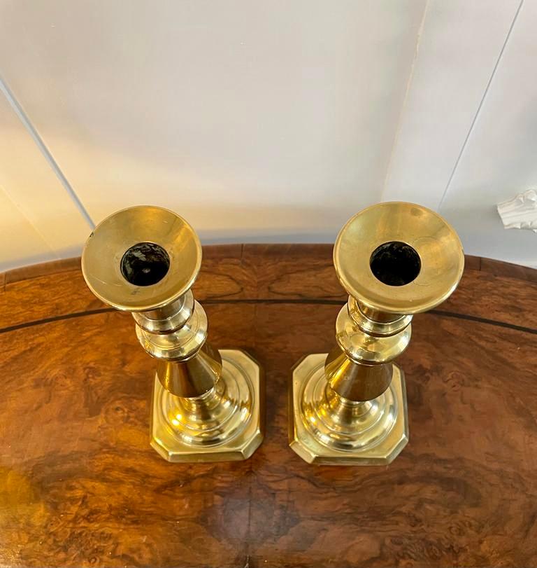 Large pair of antique Victorian brass candlesticks having a shaped turned column and raised on a square stepped base

Measures: H 27.5cm
W 10.5cm
D 11cm 
Date 1860.
 