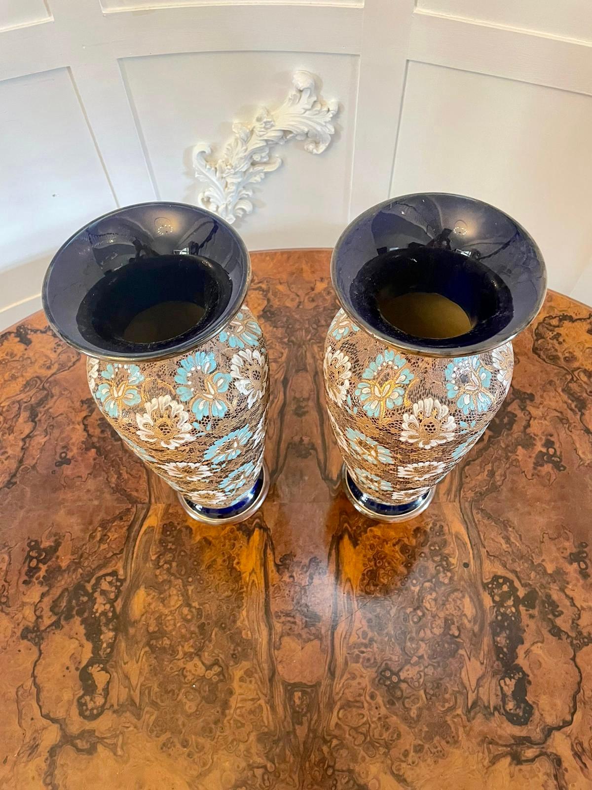 Large pair of antique Victorian Lambeth Doulton vases having fantastic floral designs on an impressed lace background; in wonderful gold, blue white colours raised on circular stepped bases. 

A beautifully crafted decorative pair. 

41 x 18 x