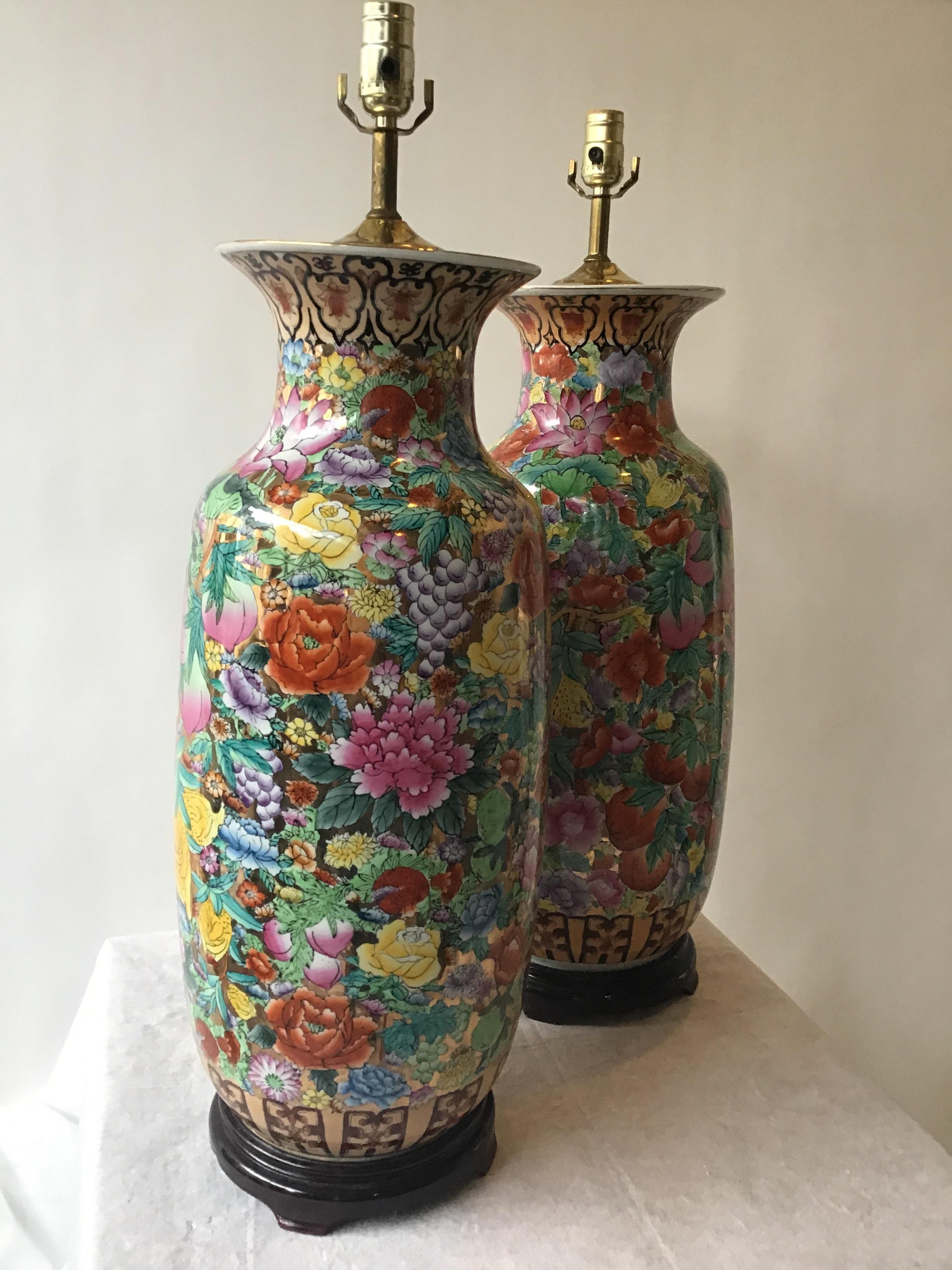 Beautiful pair of oversized gilt ceramic Asian lamps. Hand painted, on wood bases.