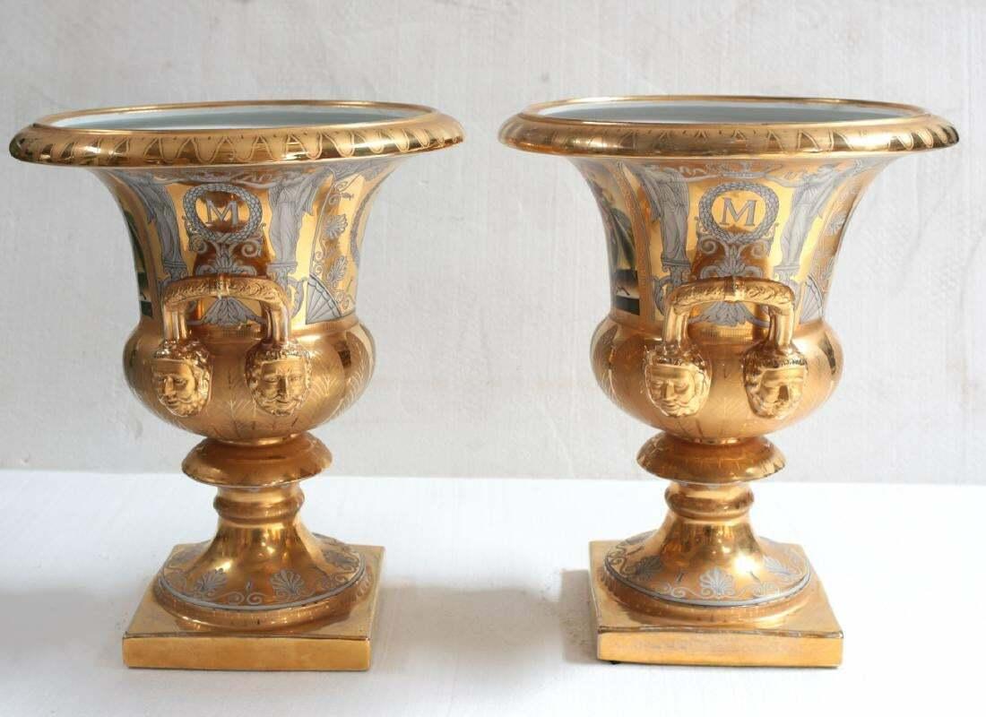  A large pair of campana form vases with twin handles and heavily gilt with hand painted floral vases on each side. Berlin mark to undersides

Additional Information: 
Type: Urns 
Dimension: 19 inches tall, 15.75 inches diameter  
Condition: Each