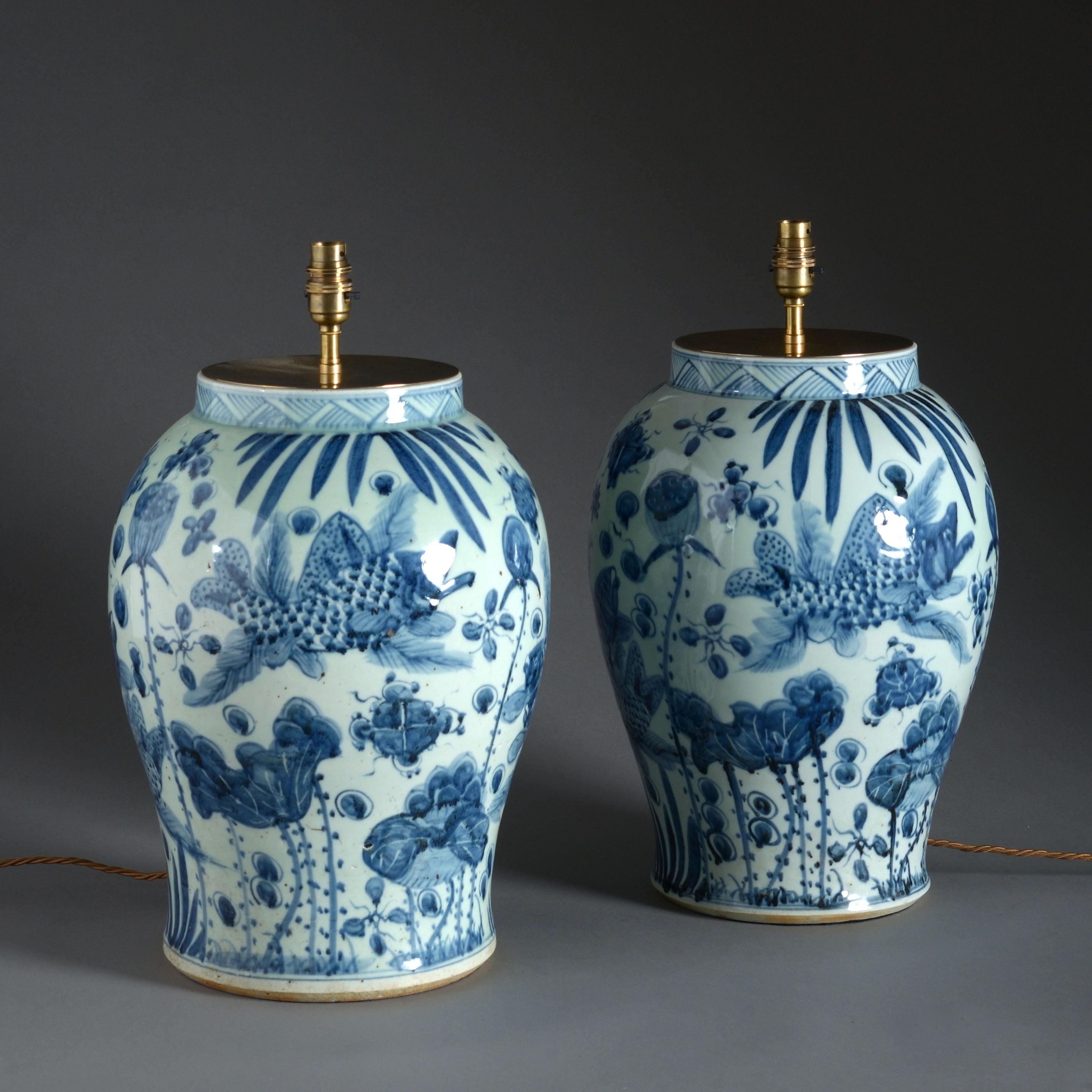 A large late 20th century pair of blue and white porcelain vases, now mounted as lamp bases.