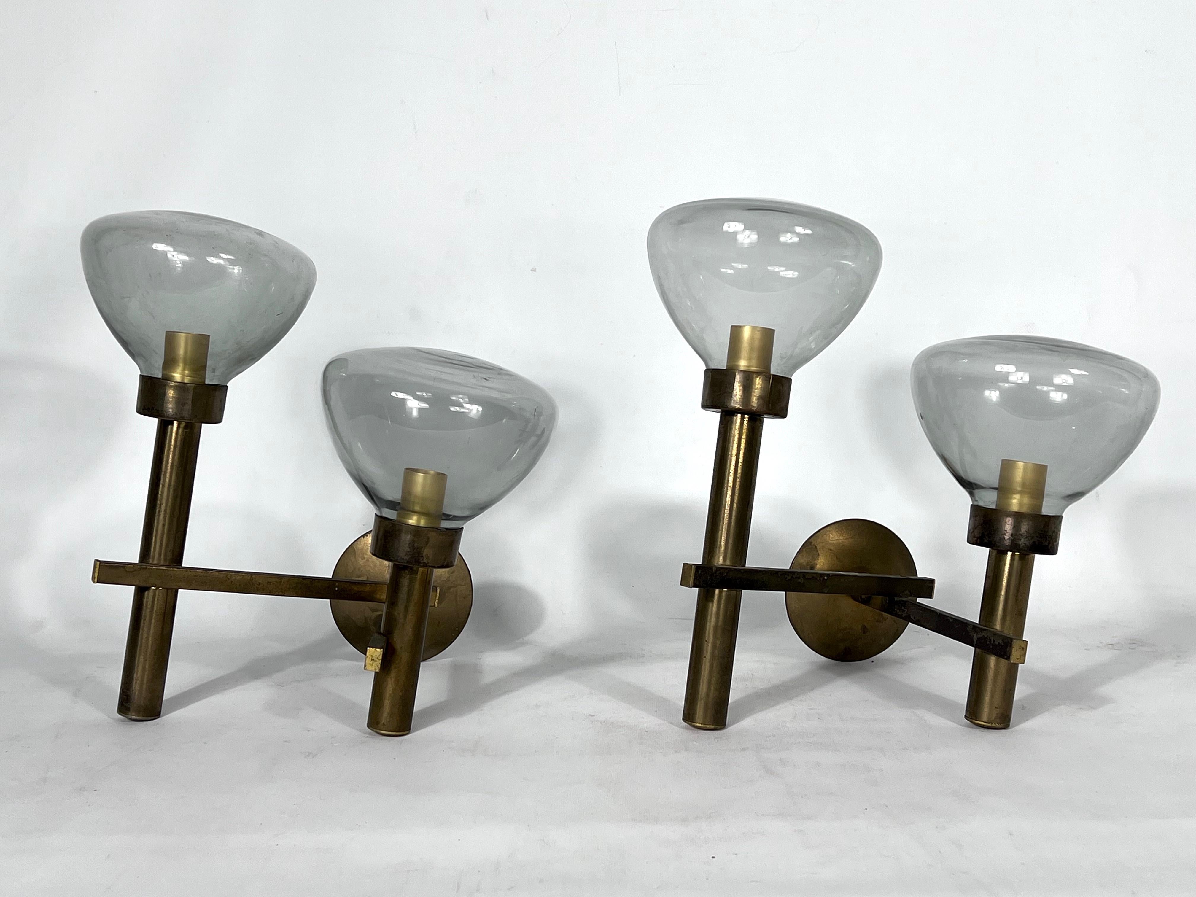 Produced by Sciolari during the 70s. Set of two large sconces made of brass and transparent grey glasses from Murano. Good vintage conditions with new wiring. Brass with original patina and trace of use and age. Each sconce mounts two sockets for