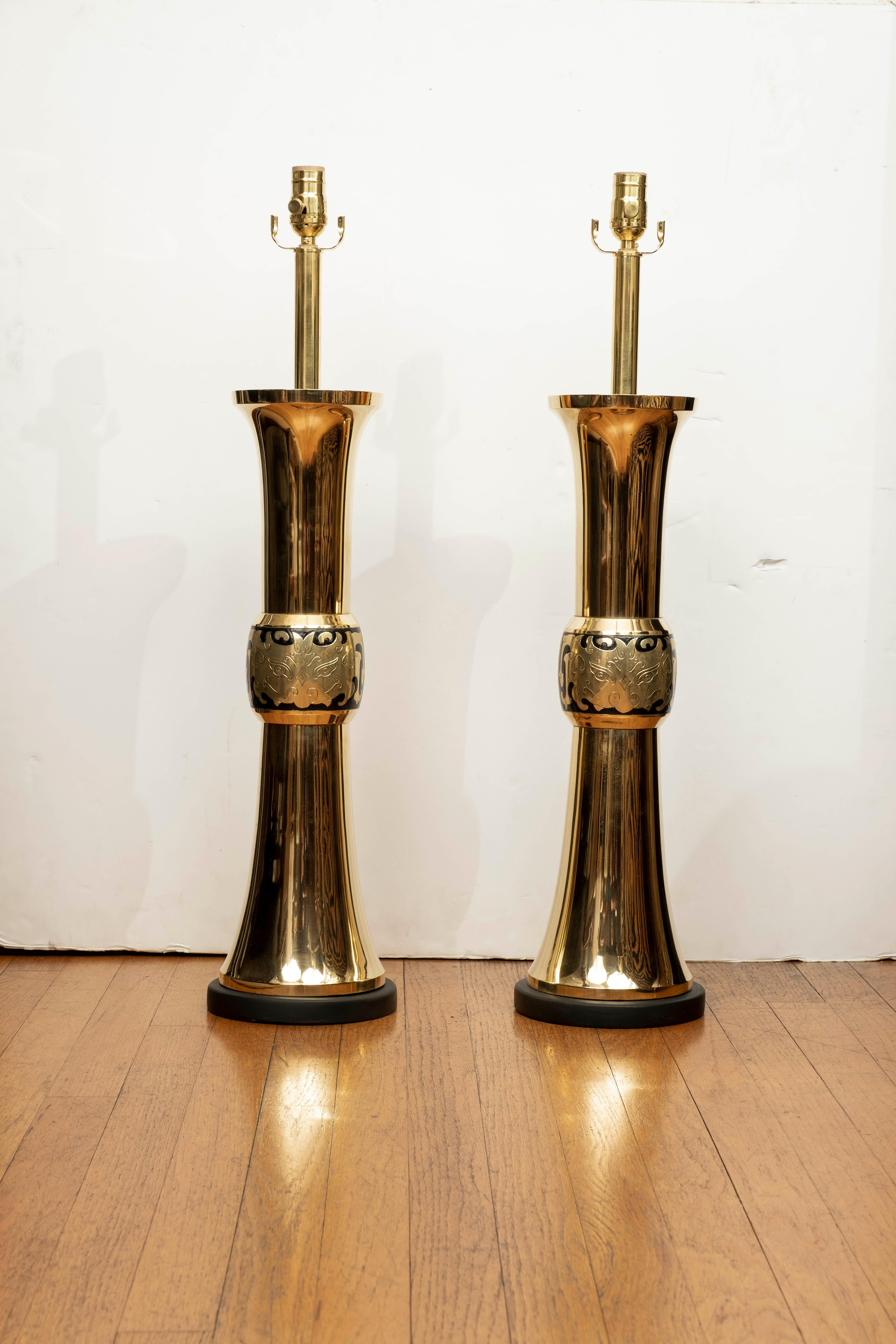 Large pair of brass lamps by James Mont. This stunning pair of Hollywood Regency Asian Modern brass lamps are statement pieces and have been newly wired with new sockets for the U.S. Market.