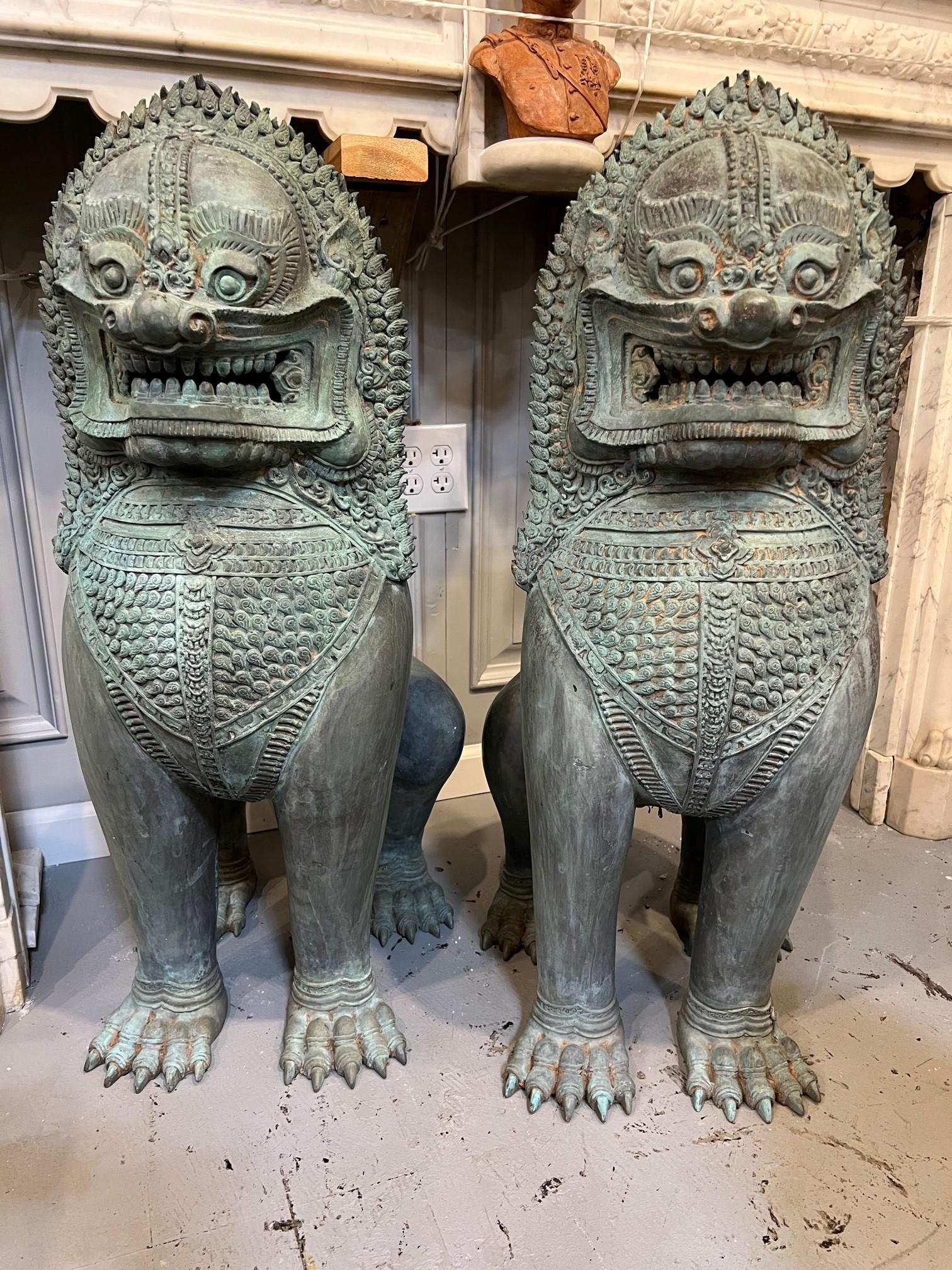 A magnificent pair of bronze Singha Temple Lions, a Thai mythical creature in the form of a lion that has been a big part of Thai history guarding the entrances to the many Buddhist Temples.  It is common to see a pair of theses mythical lions