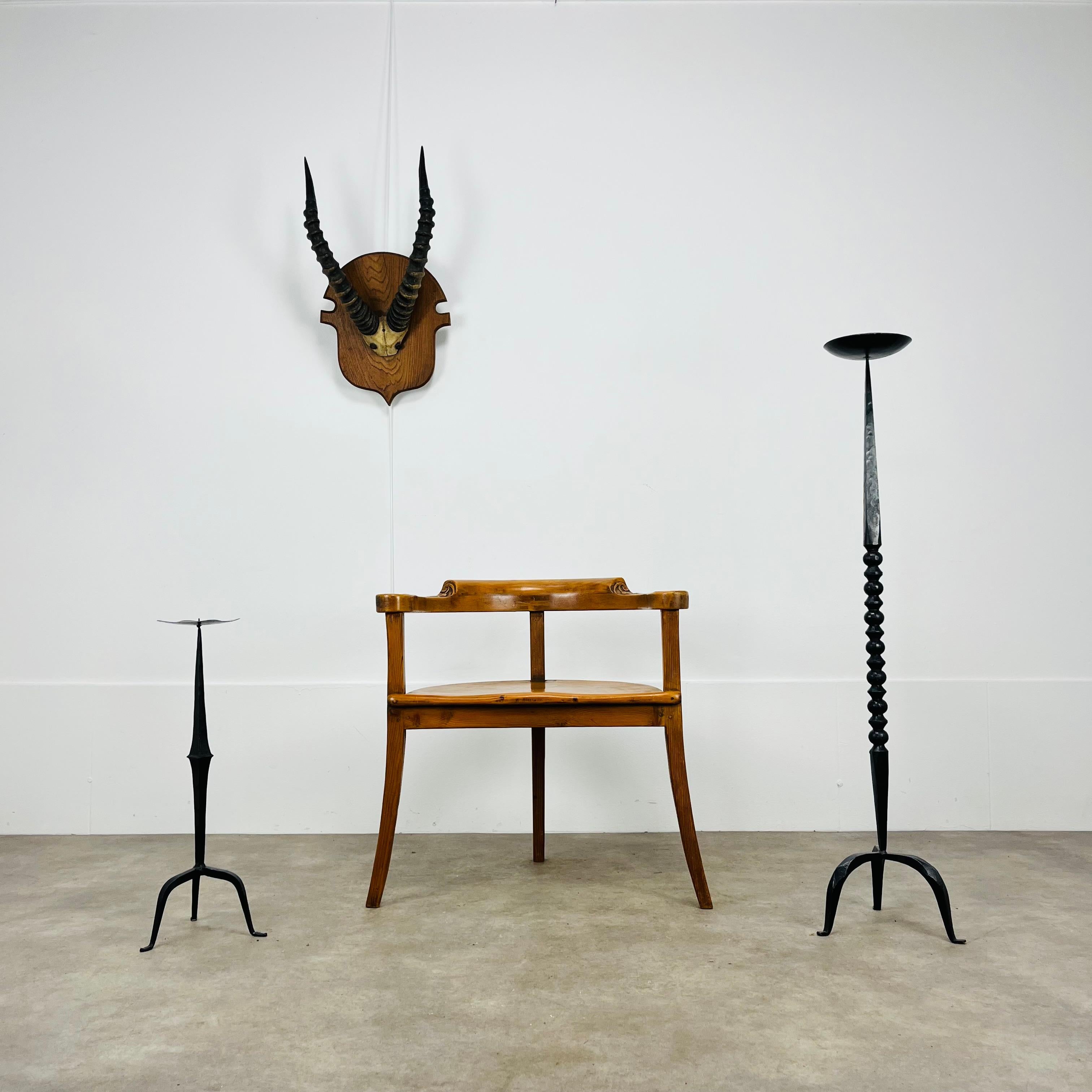 Large pair of mid century and brutalist style wrought iron floor candelabras. 
Measurements of the bigger one : height 119 cm, width 28 cm, depth 24 cm
Measurements of the smaller one : height 61,5 cm, width 22,5 cm, depth 20,5 cm
