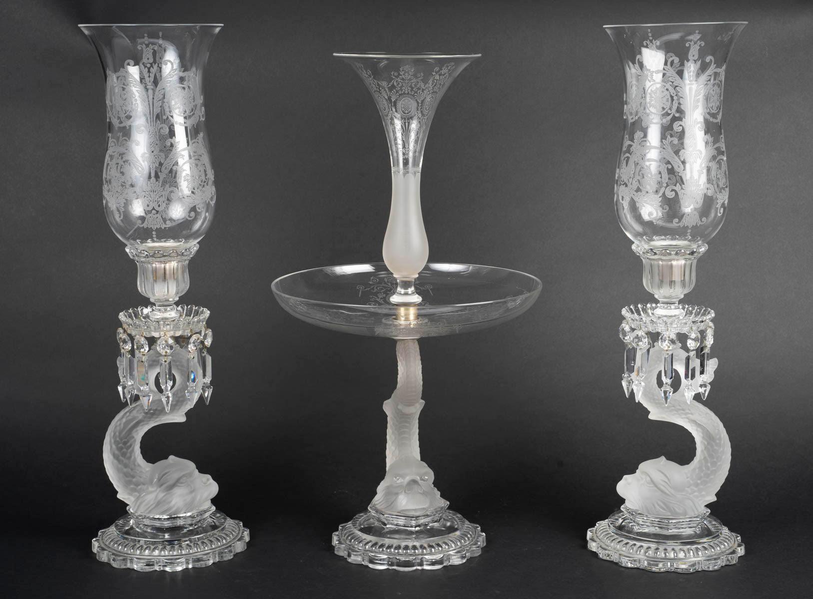 Pair of candelabra and centrepiece from the early 20th century, Napoleon III style, in Baccarat crystal.

Centrepiece: H: 58cm, D: 27cm
Candelabra: H: 58cm, D: 30cm