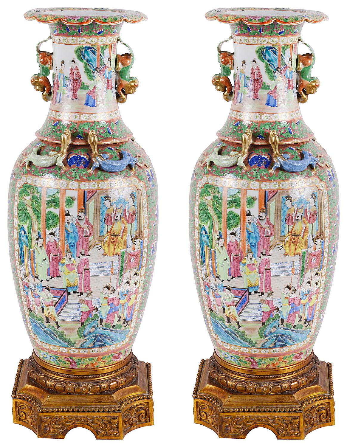 A very impressive pair of 19th century Chinese Cantonese or rose medallion vases or lamps. Each with wonderful bold colors, with classical oriental scenes of courtiers walking around pagoda buildings and gardens. The green ground having beautiful