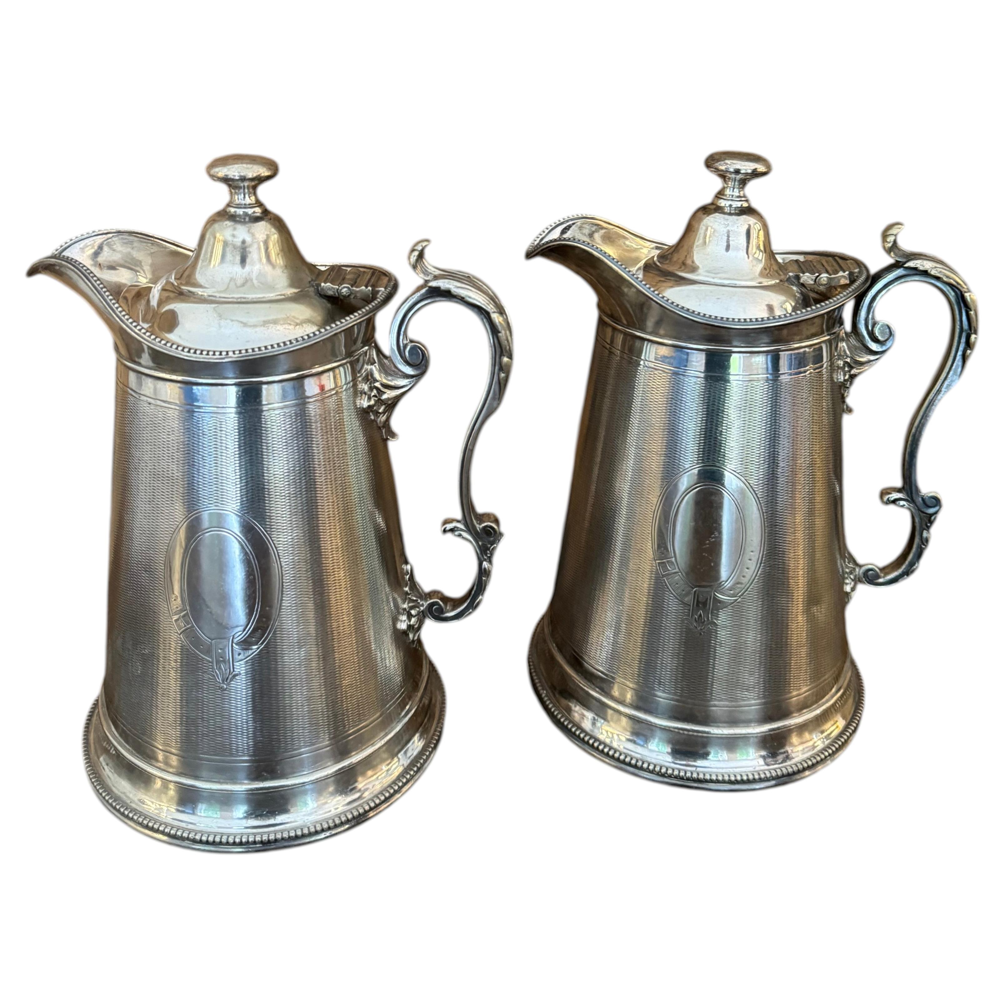 Large pair of Carrington of Regency silverplate pots, pitchers