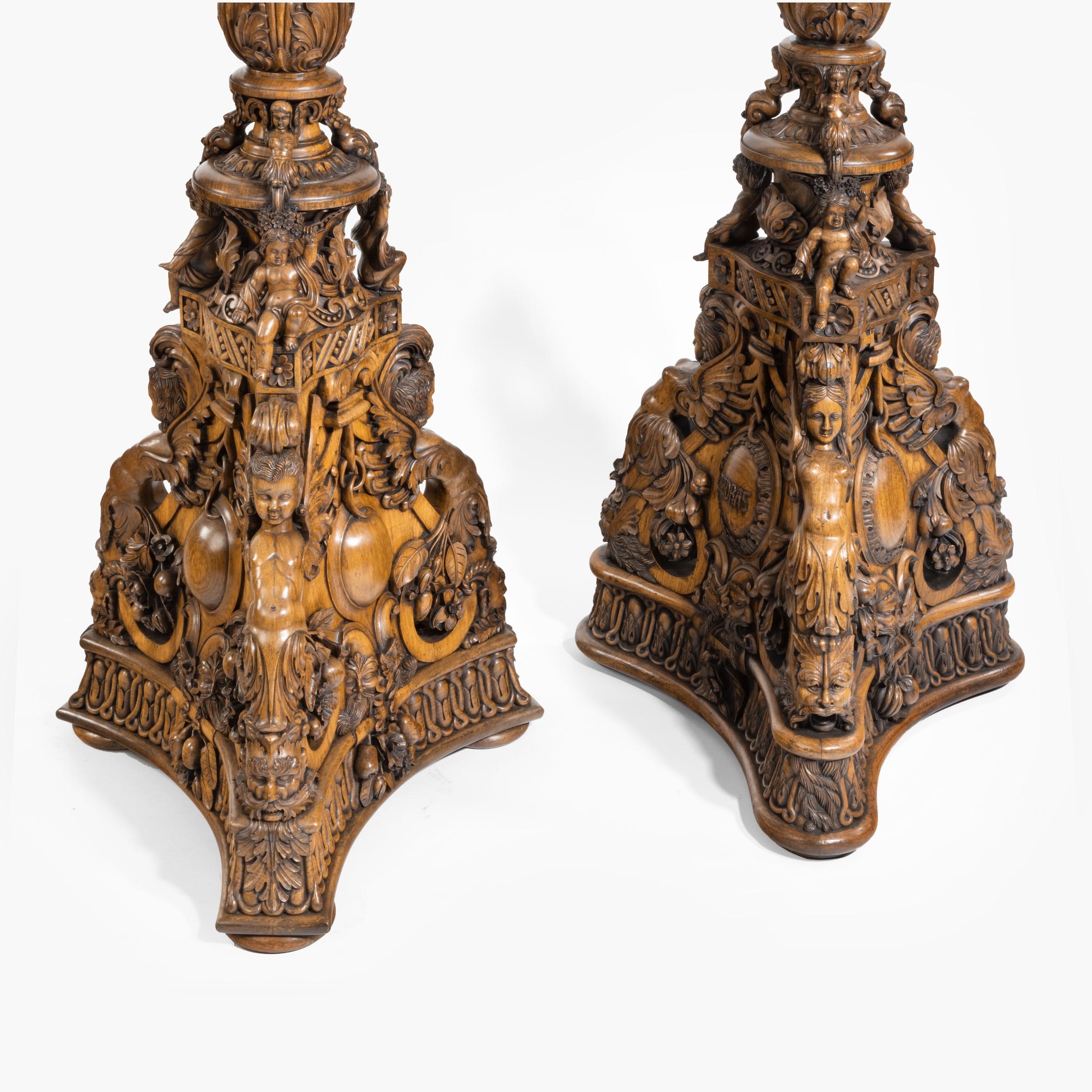 A magnificent pair of Anglo-Indian jardinière pedestals

Constructed in a flamboyantly and expertly carved teak, the bases of incurved triangular form, with putti supporting the foliate ring turned extensively carved columns, which in turn support
