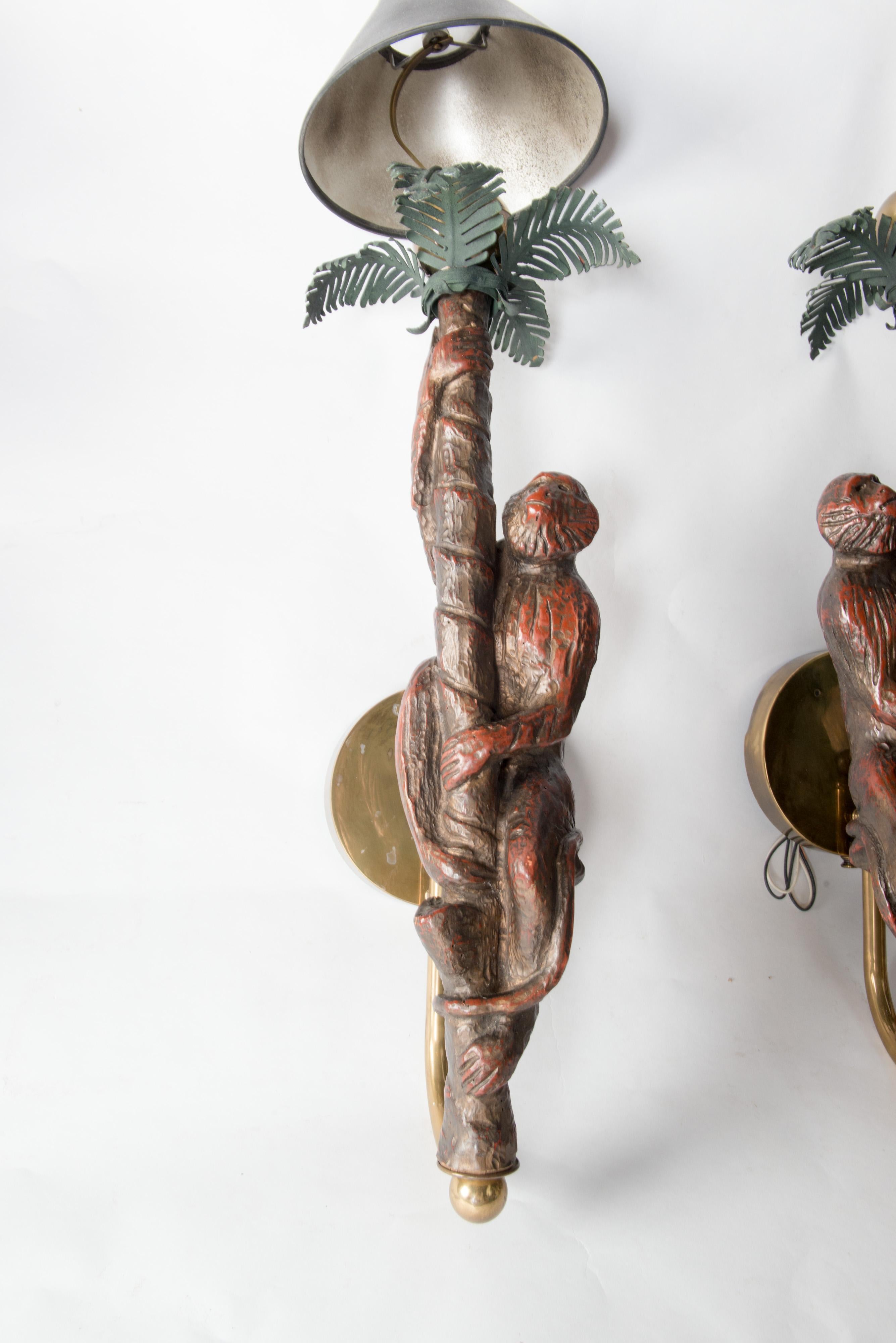 Large and substantial pair sconces of monkeys climbing on a palm trees. Carved wood with metal palm fronds. 28
