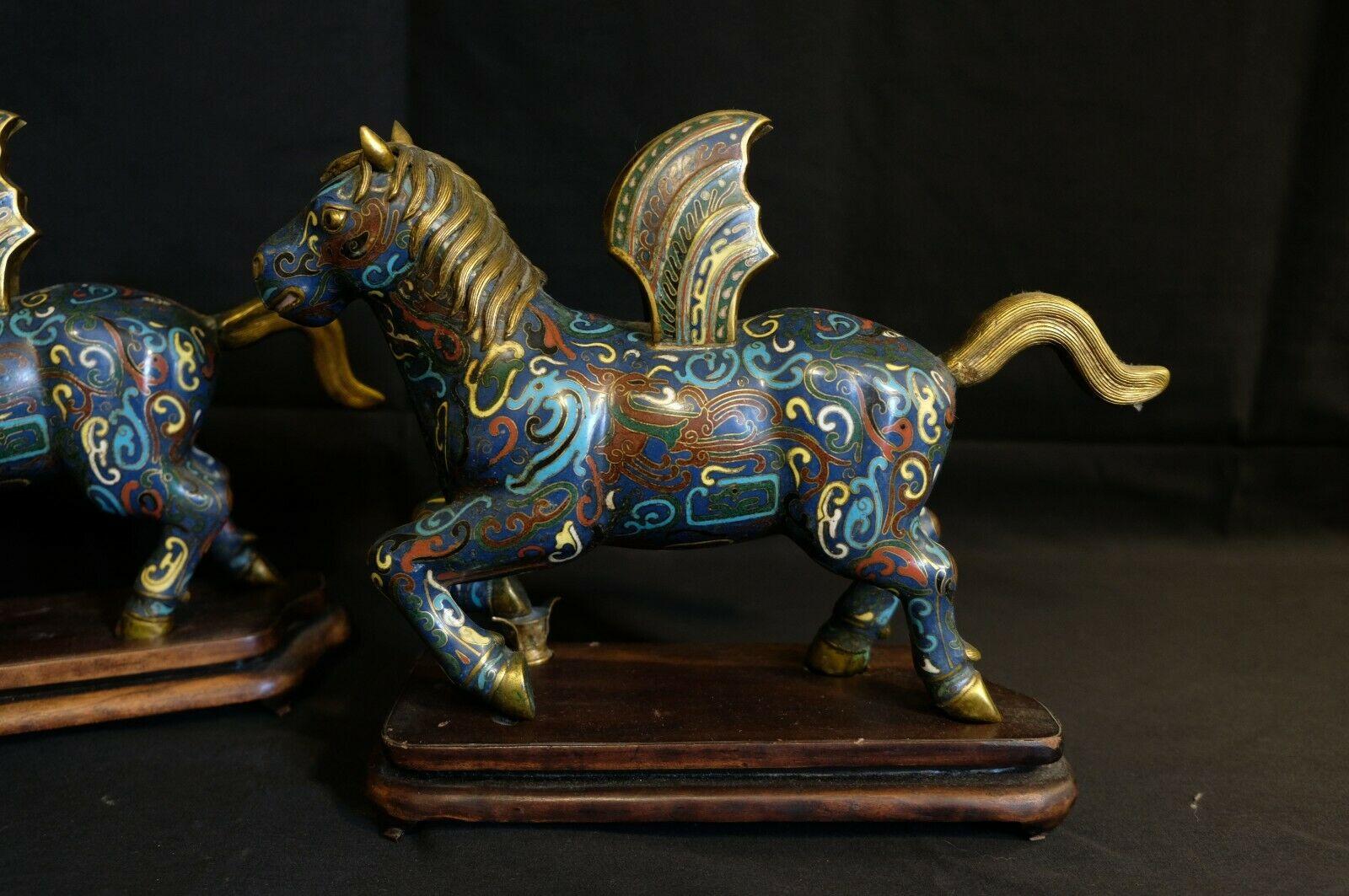 An old top quality and design of a Chinese bronze cloisonne enamel winged horses standing on the fitted wood base.


   