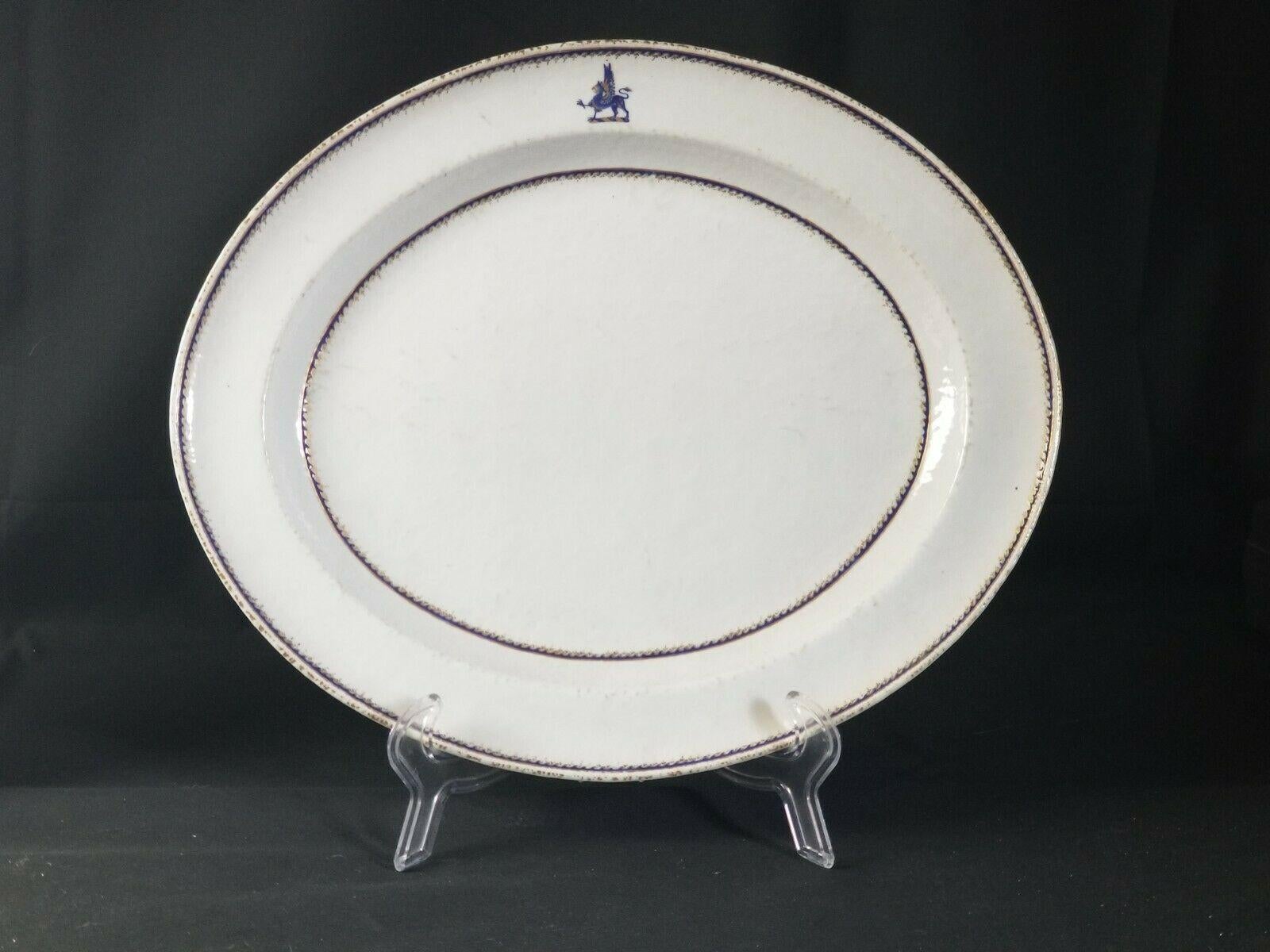 18th century, oval platters with a sphinx in gilt and cobalt blue at top of each, delicate borders in same colors, unglazed underside.


 
