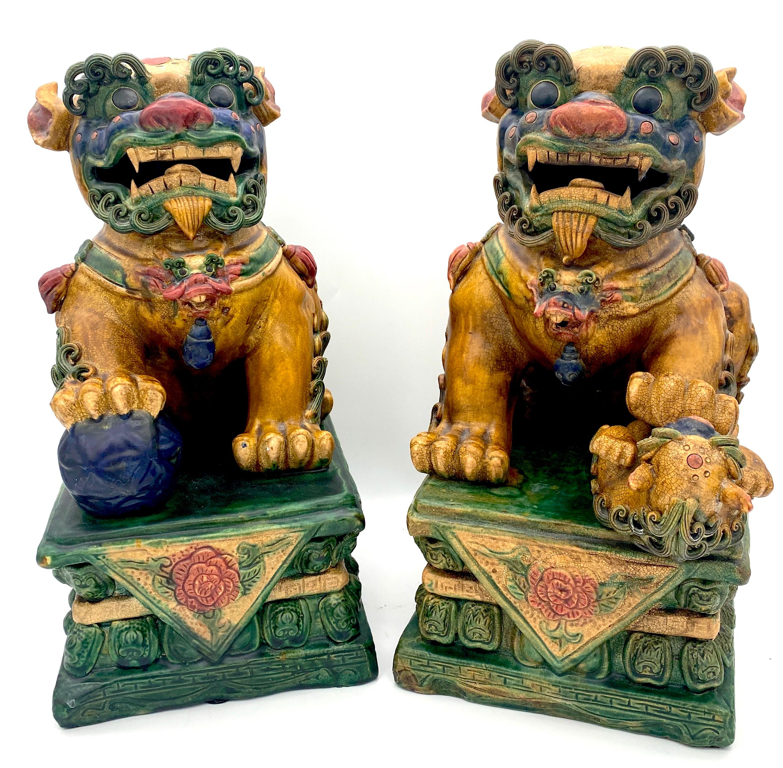 Large Pair of Chinese Export Sancai Glazed Foo Dogs
China, 20th Century 

An exquisite, large-scale Sancai glazed pair of Foo Dogs, featuring elaborately decorated Foo Dogs with remarkable applied elements. The fur detailing, particularly on the