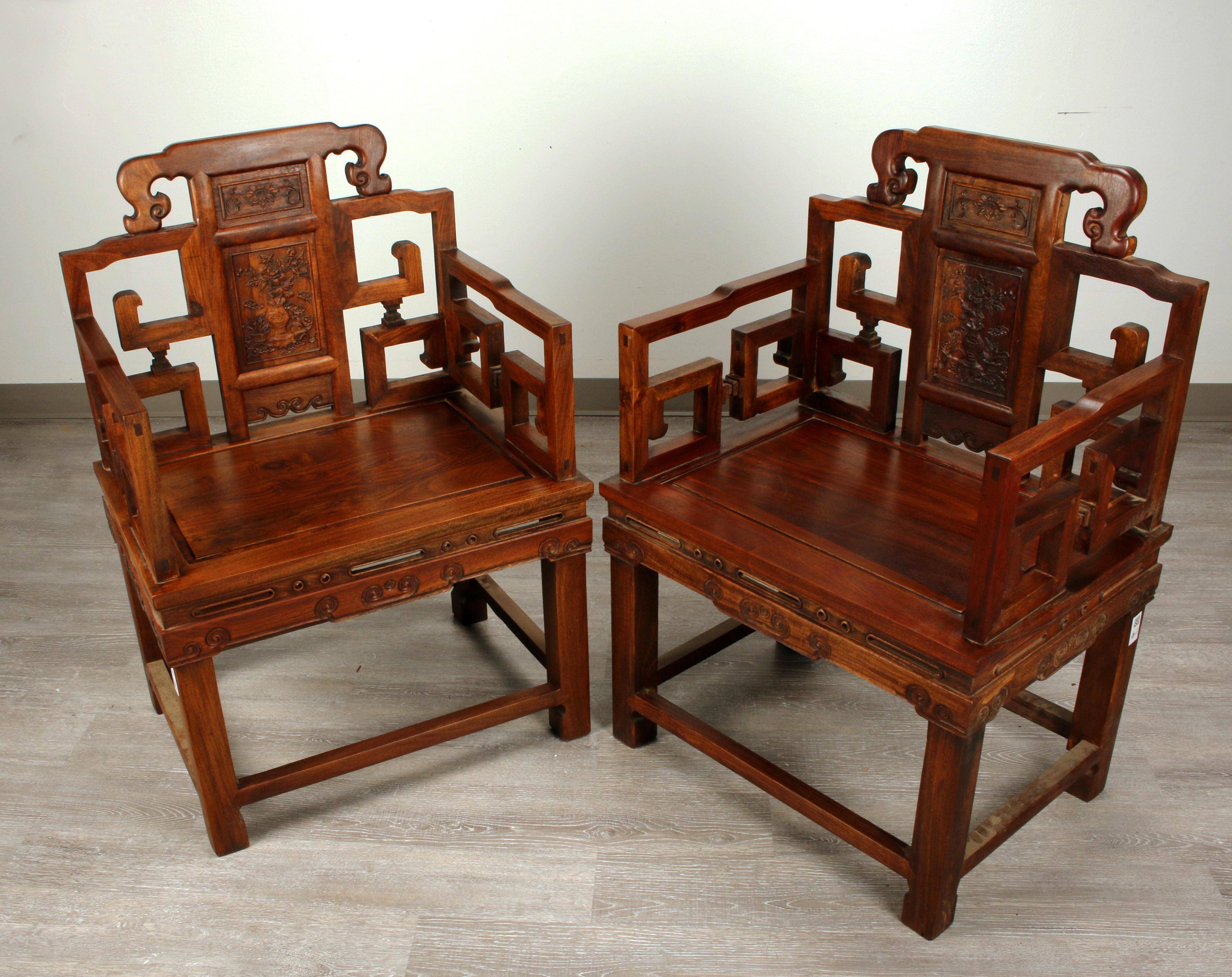 Large pair of Chinese Hongmu armchairs with rich beautiful grain patterns and carved archaic geometric back and arms. Back is carved in a vase with flowers and scholars' items.
They were made by hand with no nails, very sturdy and firm, supper