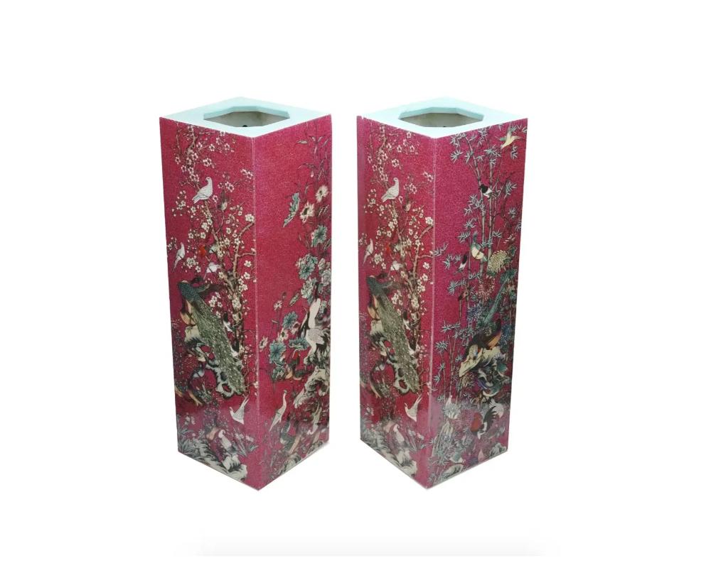 A fine pair of matching antique Chinese porcelain vases, each of a rectangular form, the exterior is covered with a deep crimson glaze and decorated with highly detailed images of various birds perching on a blooming branch on each side. Features a