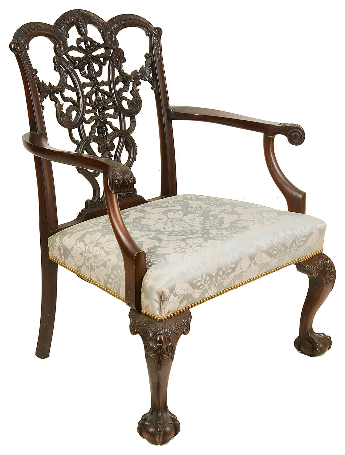 A very impressive pair of 19th century mahogany, Chippendale influenced armchairs, each having wonderful carved ribbon back and tassel decoration to the backs, stuff over upholstered seats. Raised on carved cabriole legs that terminate in ball and