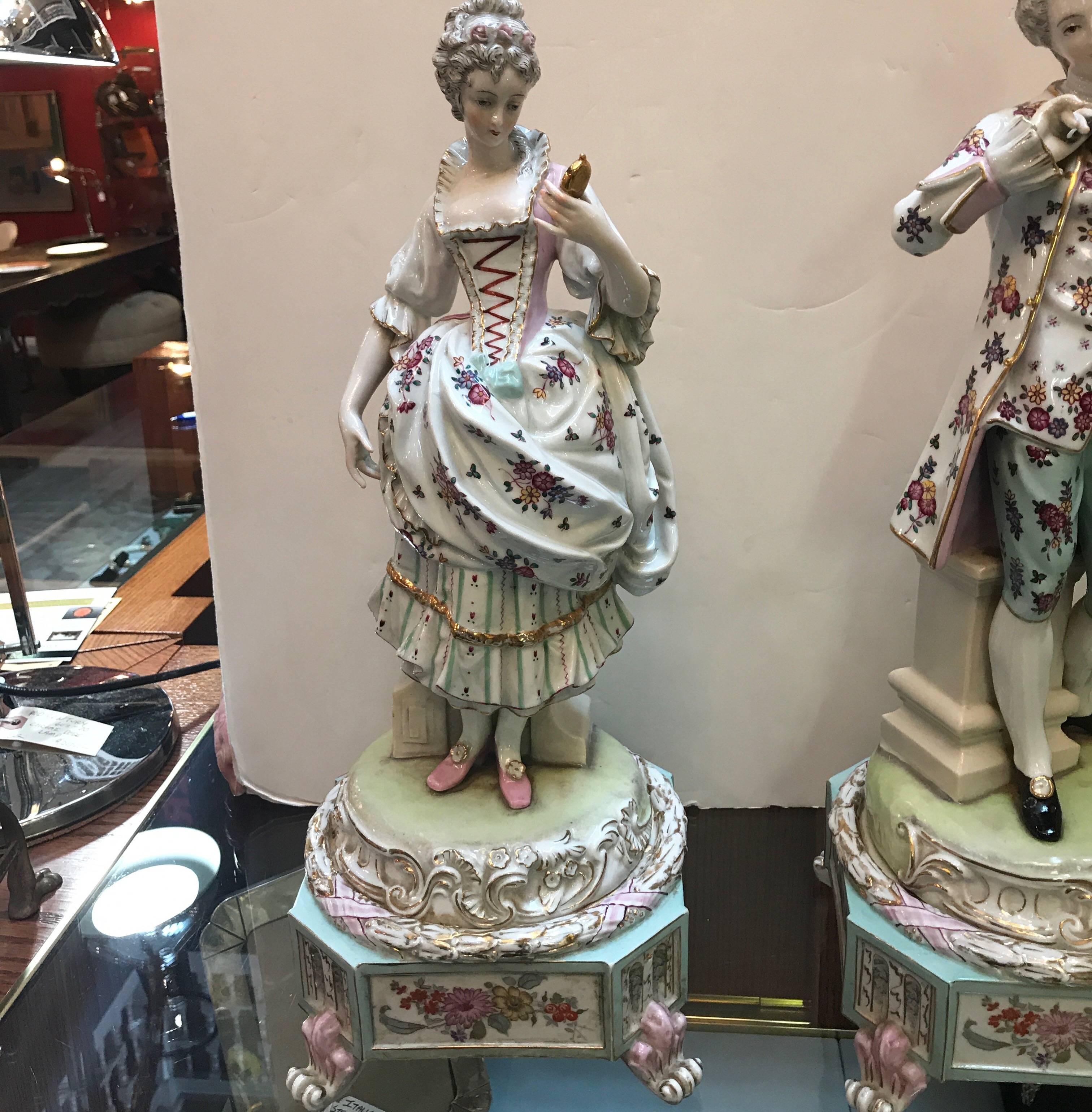 Exceptional pair of large Dresden hand painted porcelain figures of an aristocratic couple. Both figures entirely hand-painted in great detail. These pieces are of Meissen quality but unmarked.
