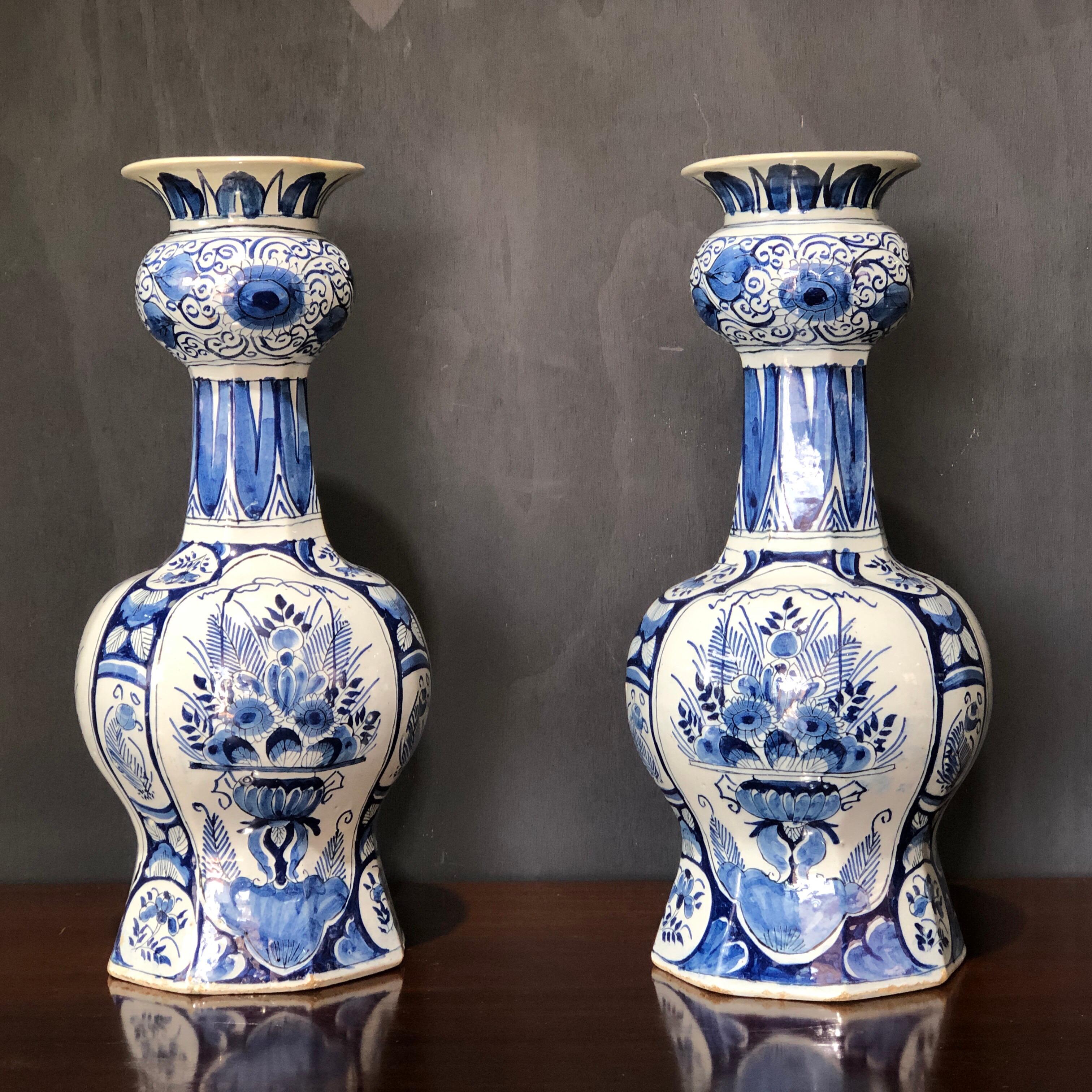 Large pair of Dutch delft octagonal onion-shaped vases, painted inglaze with panels of flower baskets in the Oriental manner, the necks with leaves and the neck swell with chrysanthemum flowers and scrolling leaves.
Blue '3' mark,
first half of