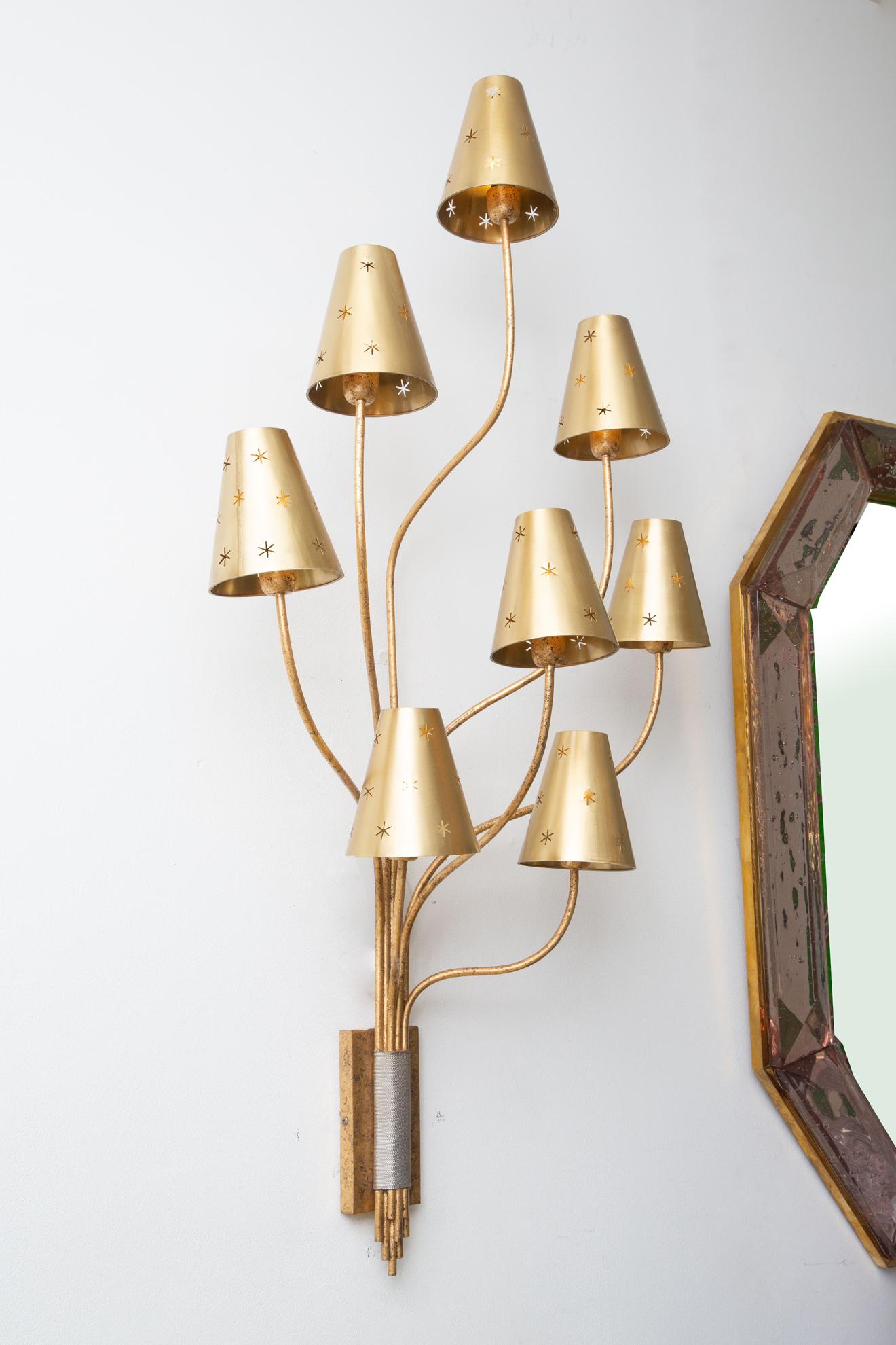 Large pair of 8 arms gilded metal wall sconces with brass perforated shades.