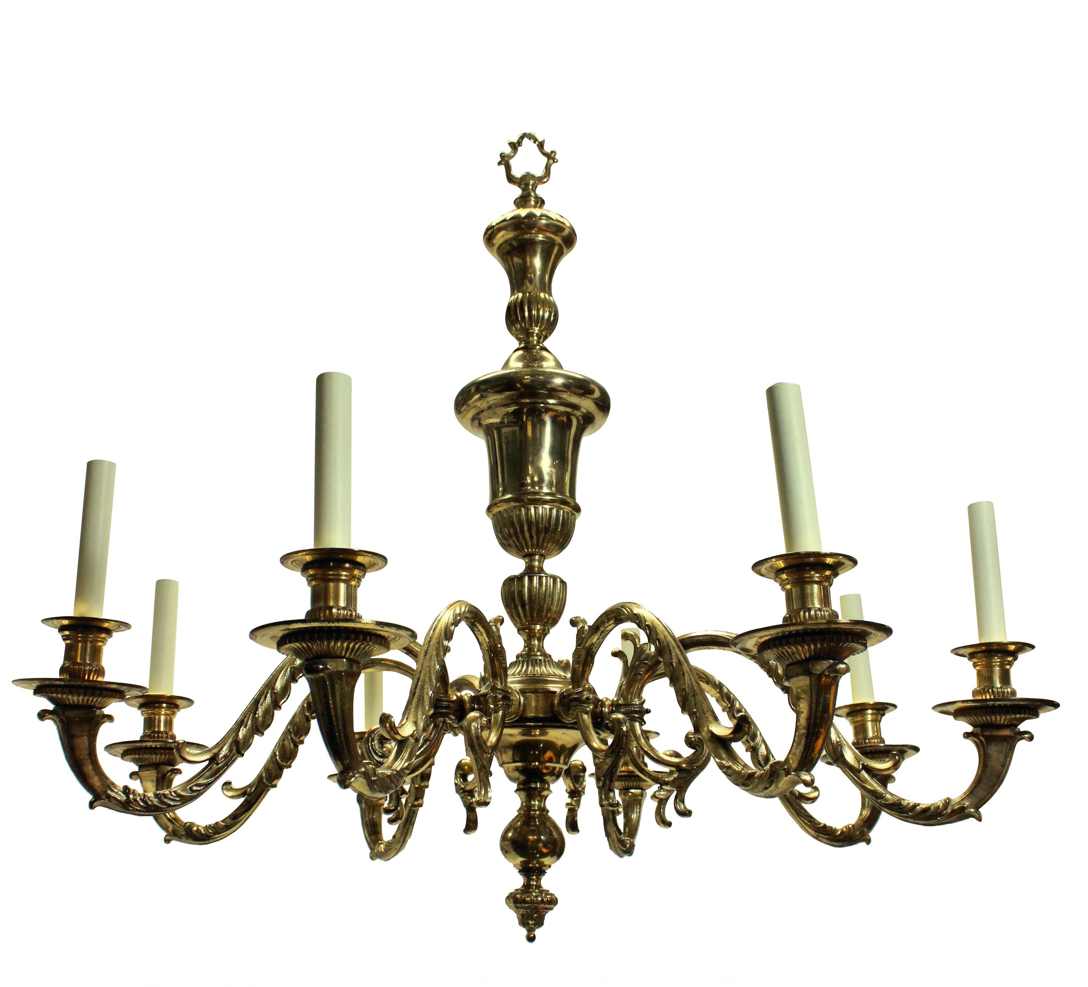 A large and impressive pair of Charles II style gilt brass eight branch chandeliers, with acanthus detailing and central urn. Each with decorative ceiling canopy and chain. Newly electrified.