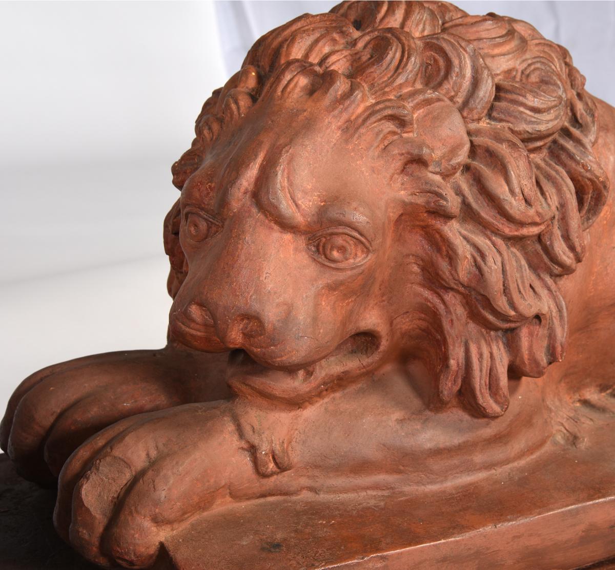 A fine pair of antique English terracotta recumbent lions on later bases. The lions are stamped on the lower edges. Both figures have been filled with concrete a long time ago, circa 1830.
Measures: Figures: 30