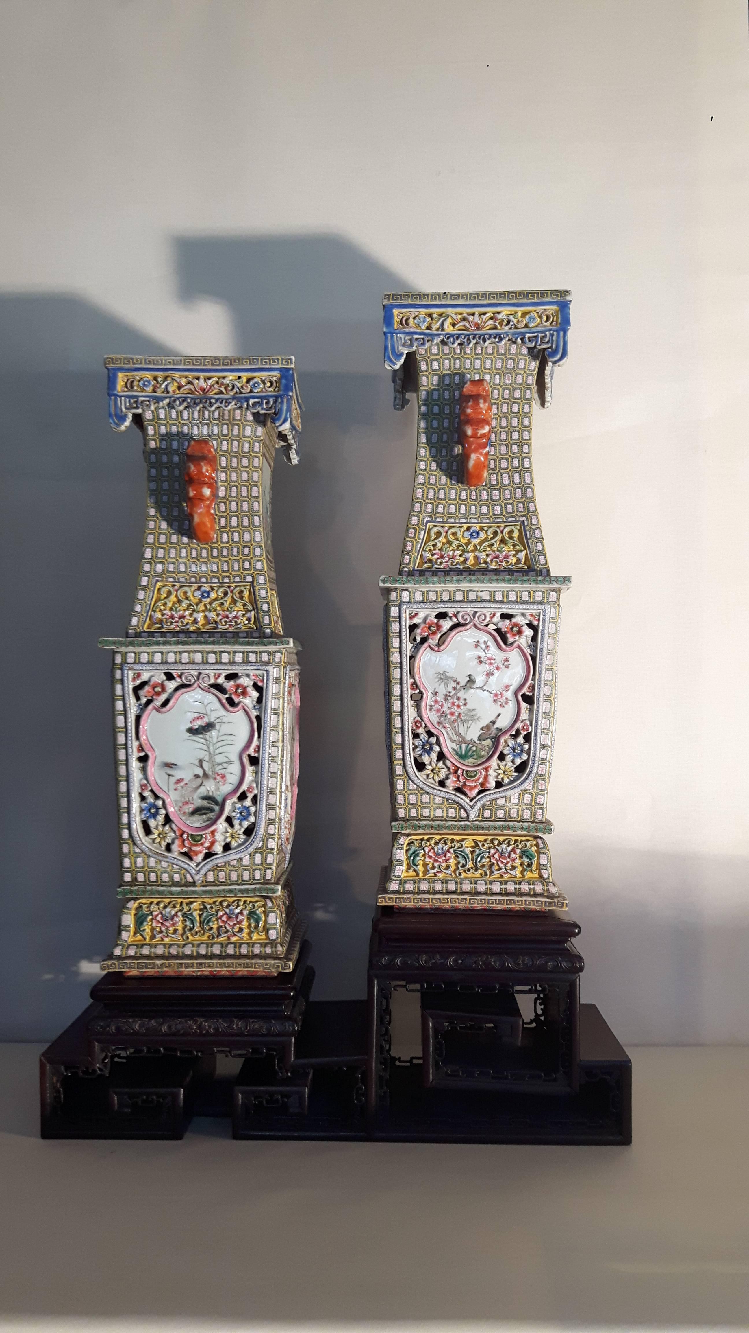 A very rare pair chines famile rose vases. Each elaborately formed with openwork diaper panels with moulded foliate motifs, the neck flanked with elephant head handles, with an overhanging mouth rim, scrolled double wood Stand. Guangxu six
