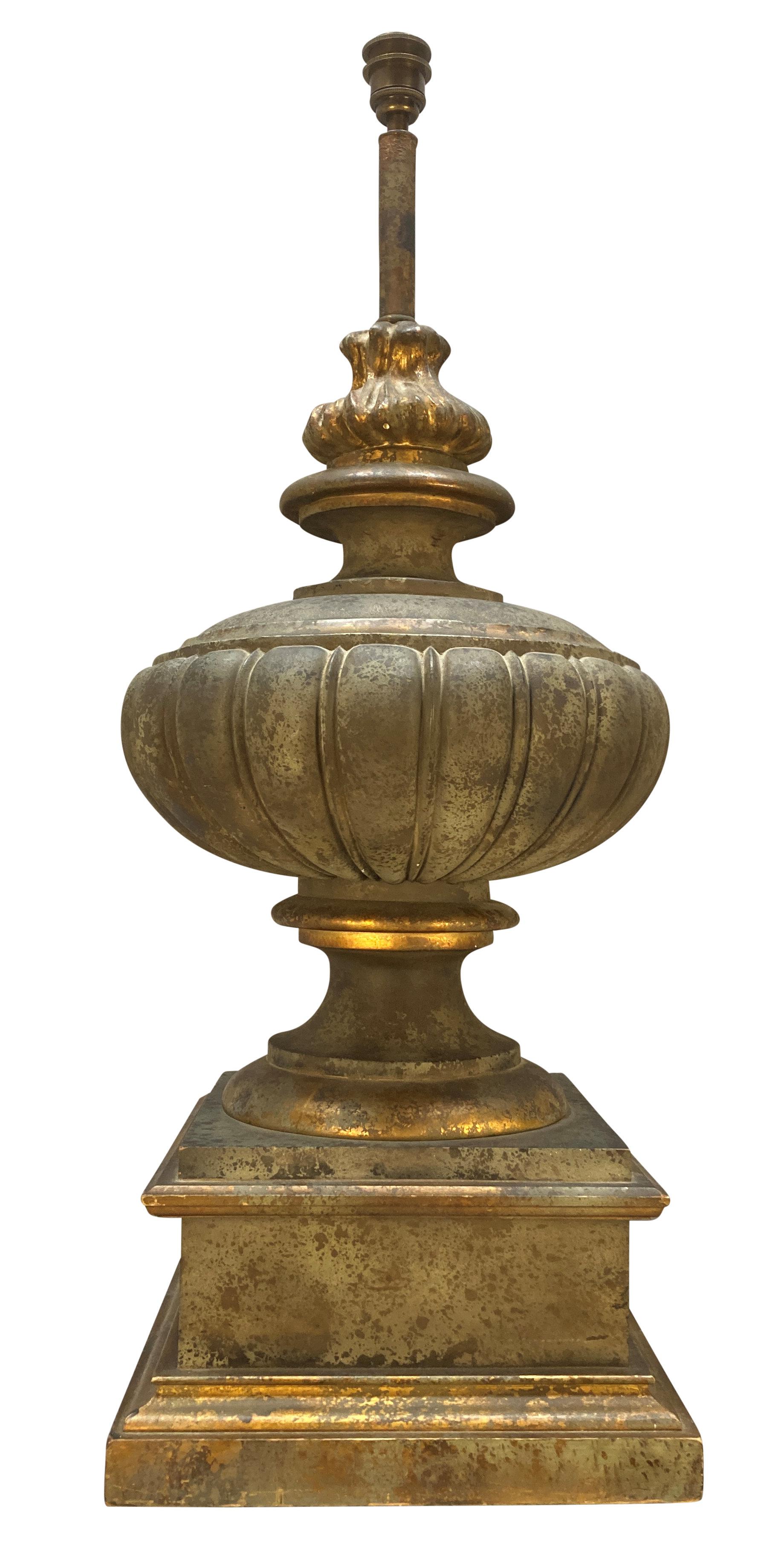 A pair of large English faux bronze Classical urn lamps, on plinths, with flambe finials. Carved wood, painted and gilded.